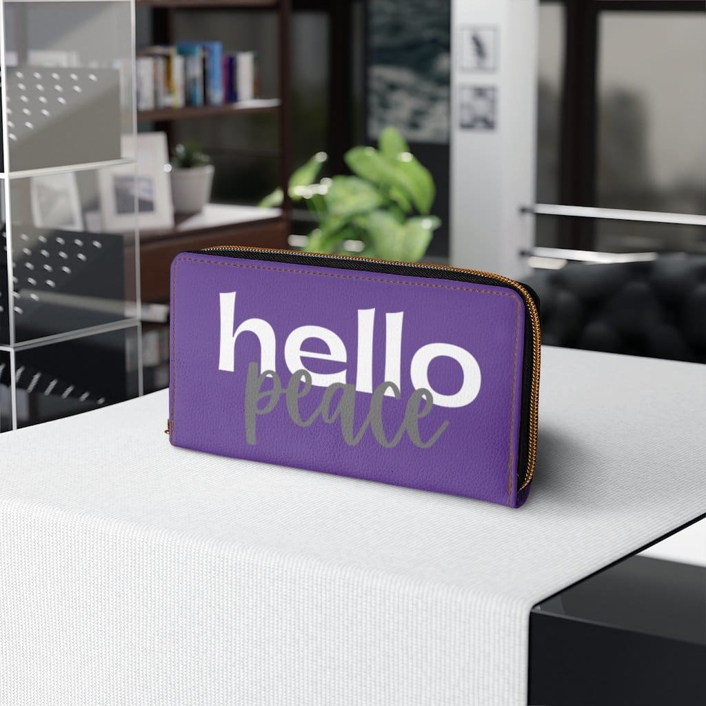 Purple and white zip wallet for women featuring 'Hello Peace' design, made from cruelty-free faux leather with gold stitching.