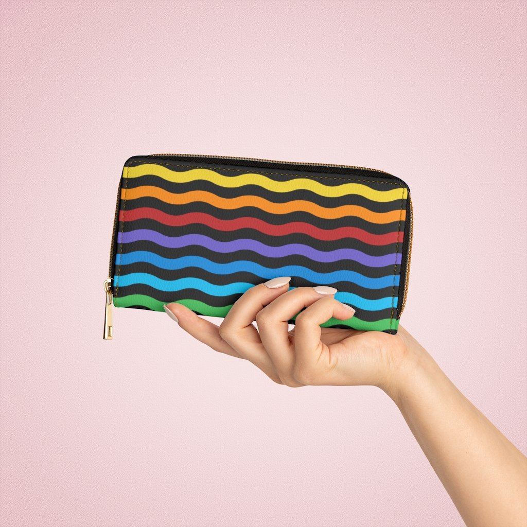 Colorful women's zip wallet featuring a rainbow swirl design, made from faux leather with multiple pockets for cards and cash.