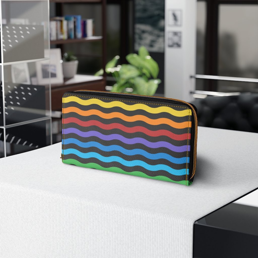 Colorful women's zip wallet featuring a rainbow swirl design, made from faux leather with multiple pockets for cards and cash.