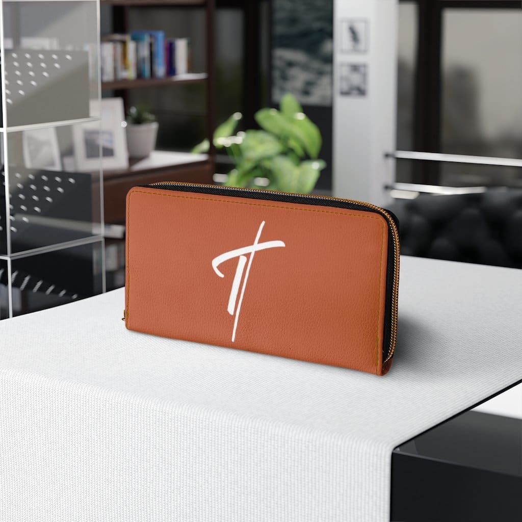 Women's rust brown and white zip wallet with cross design, showcasing its stylish and functional features.