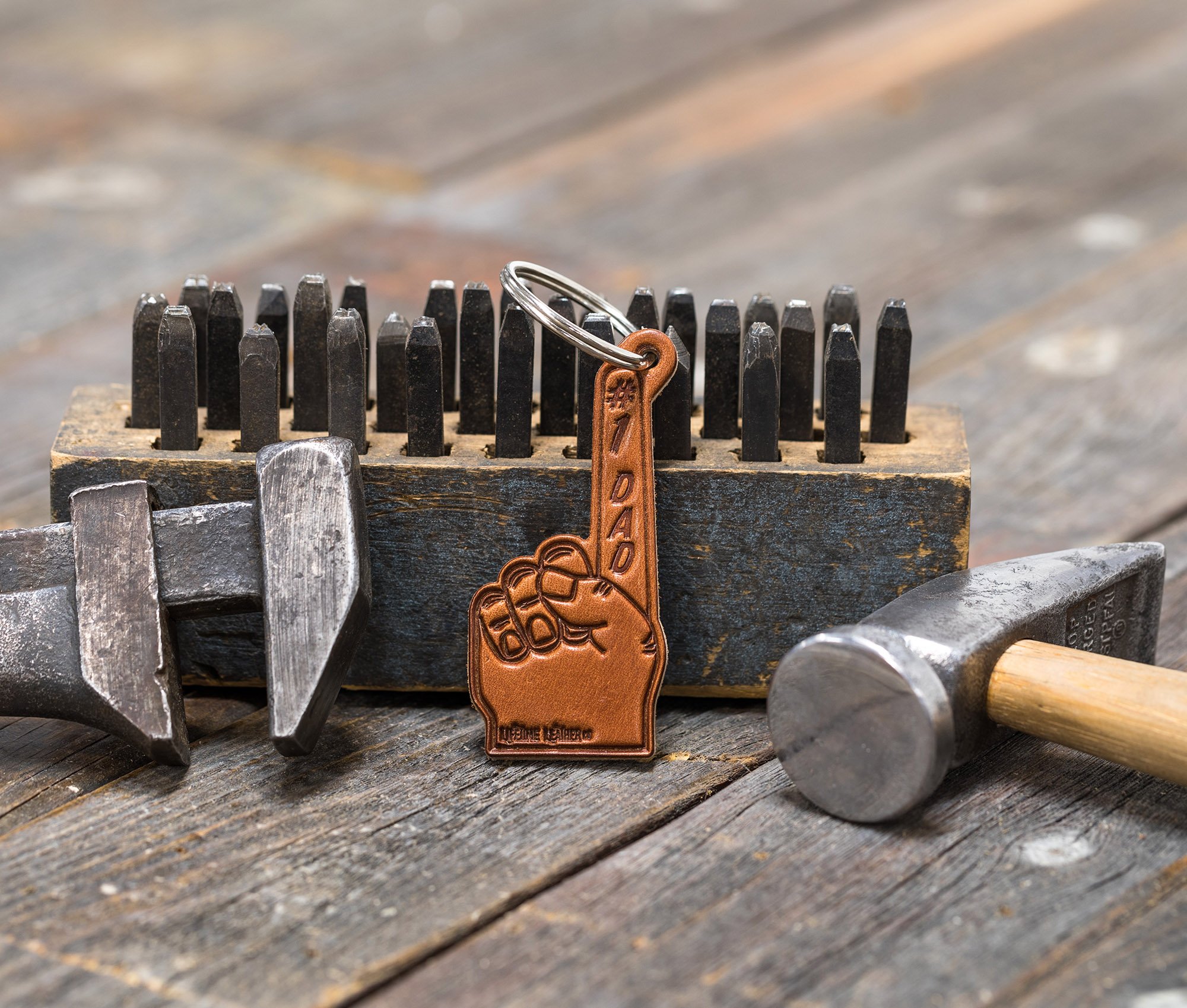 A stylish #1 Dad Leather Keychain made from genuine full grain leather, featuring a heat-stamped design and attached key ring.