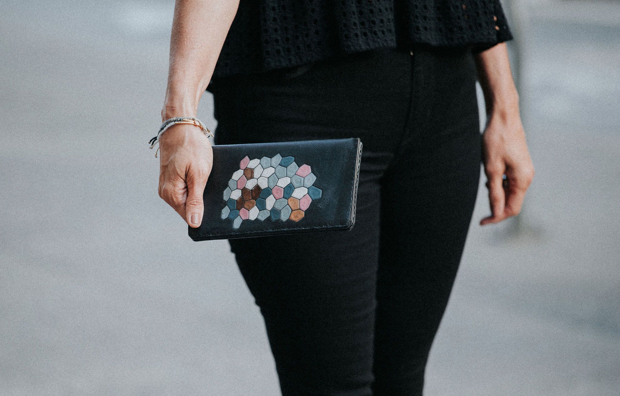 ACQUA Clutch made from vegtan leather with a water-inspired design, featuring five interior pockets.