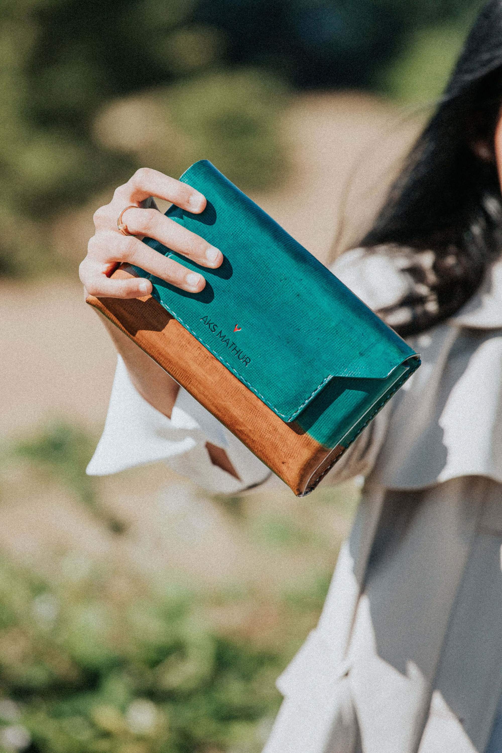 AER Belt-Bag in dual tone blue and sepia, crafted from natural vegetable tanned leather, showcasing its minimalist design and magnetic closure.