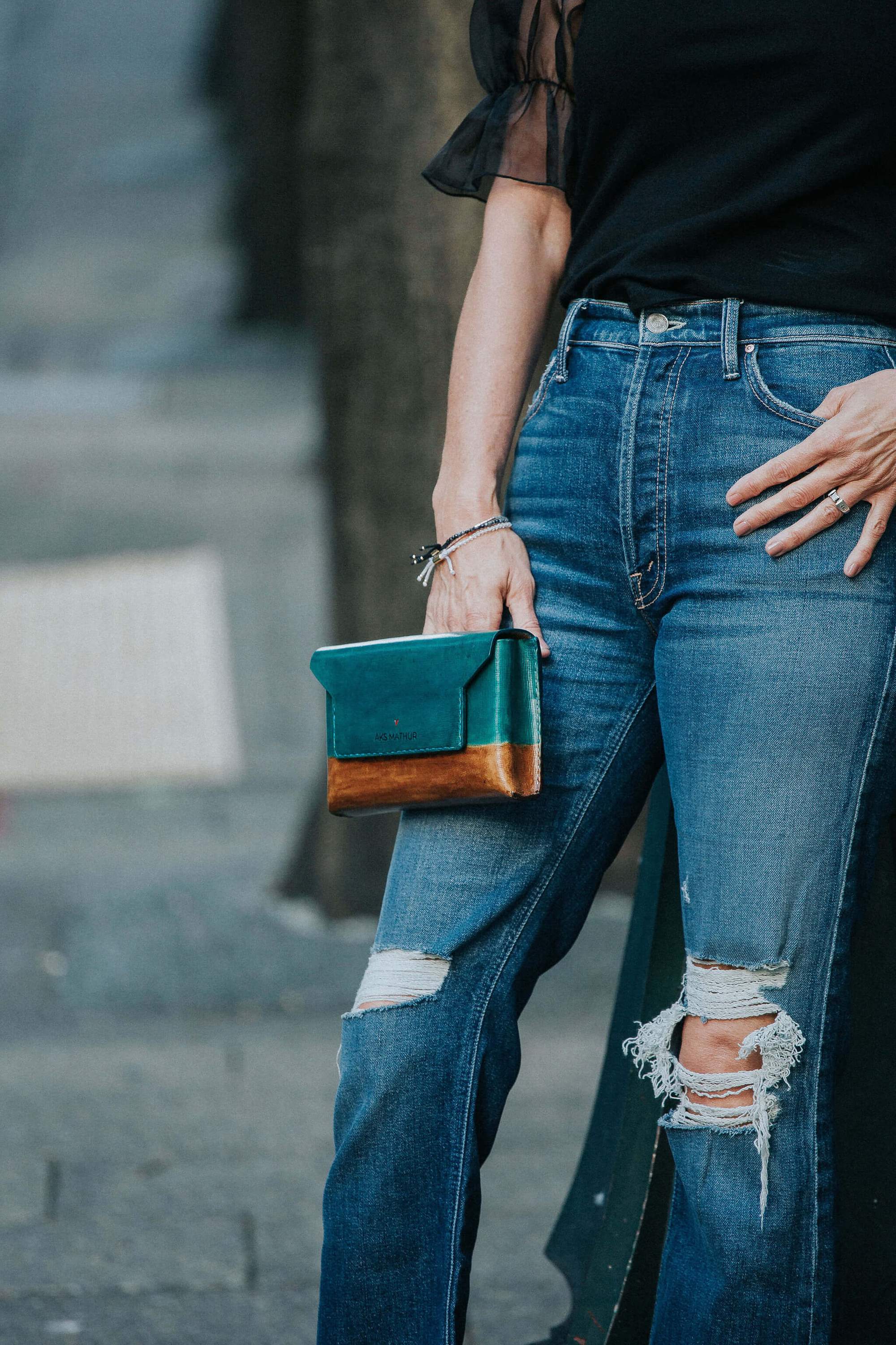 AER Belt-Bag in dual tone blue and sepia, crafted from natural vegetable tanned leather, showcasing its minimalist design and magnetic closure.