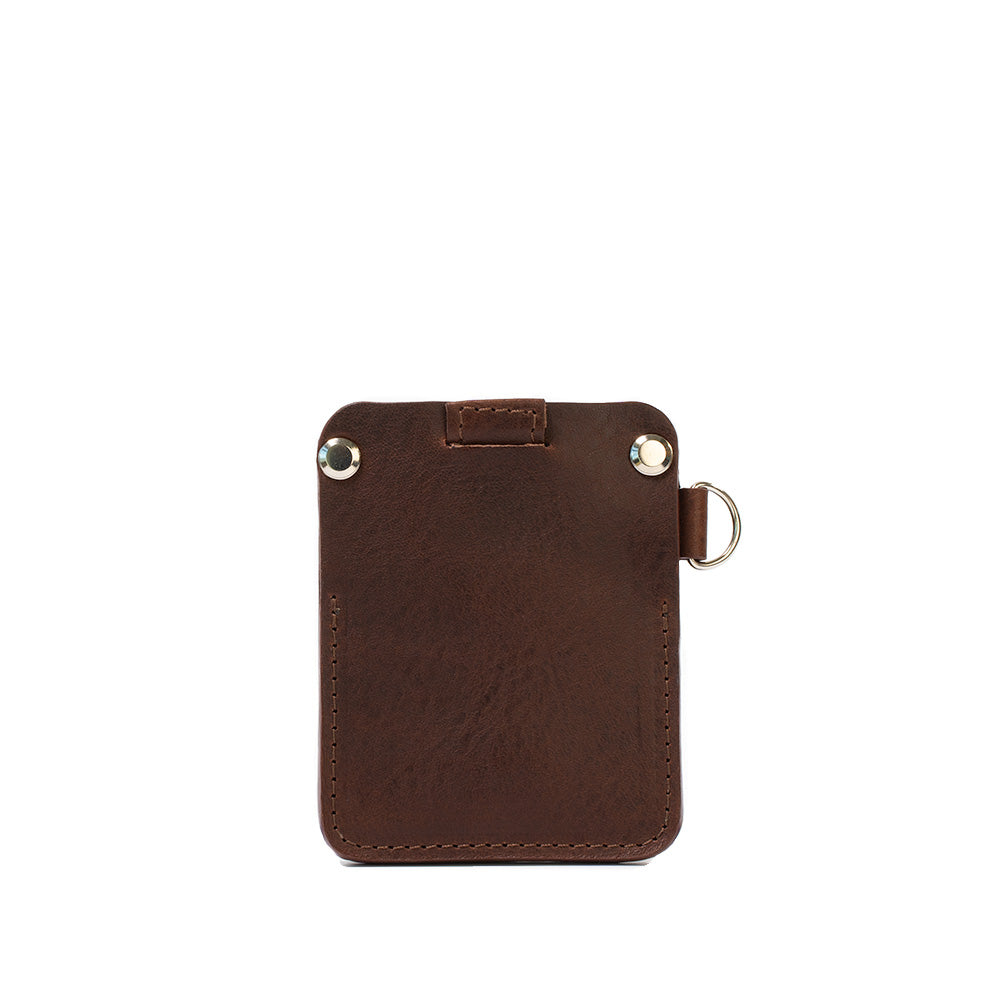 A stylish leather AirTag wallet with D-ring, showcasing its compact design and hidden AirTag pocket, perfect for holding cards securely.