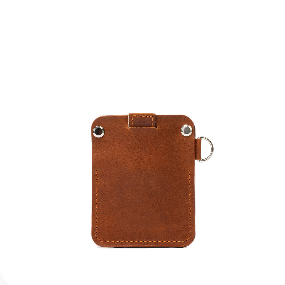 A stylish leather AirTag wallet with D-ring, showcasing its compact design and hidden AirTag pocket, perfect for holding cards securely.