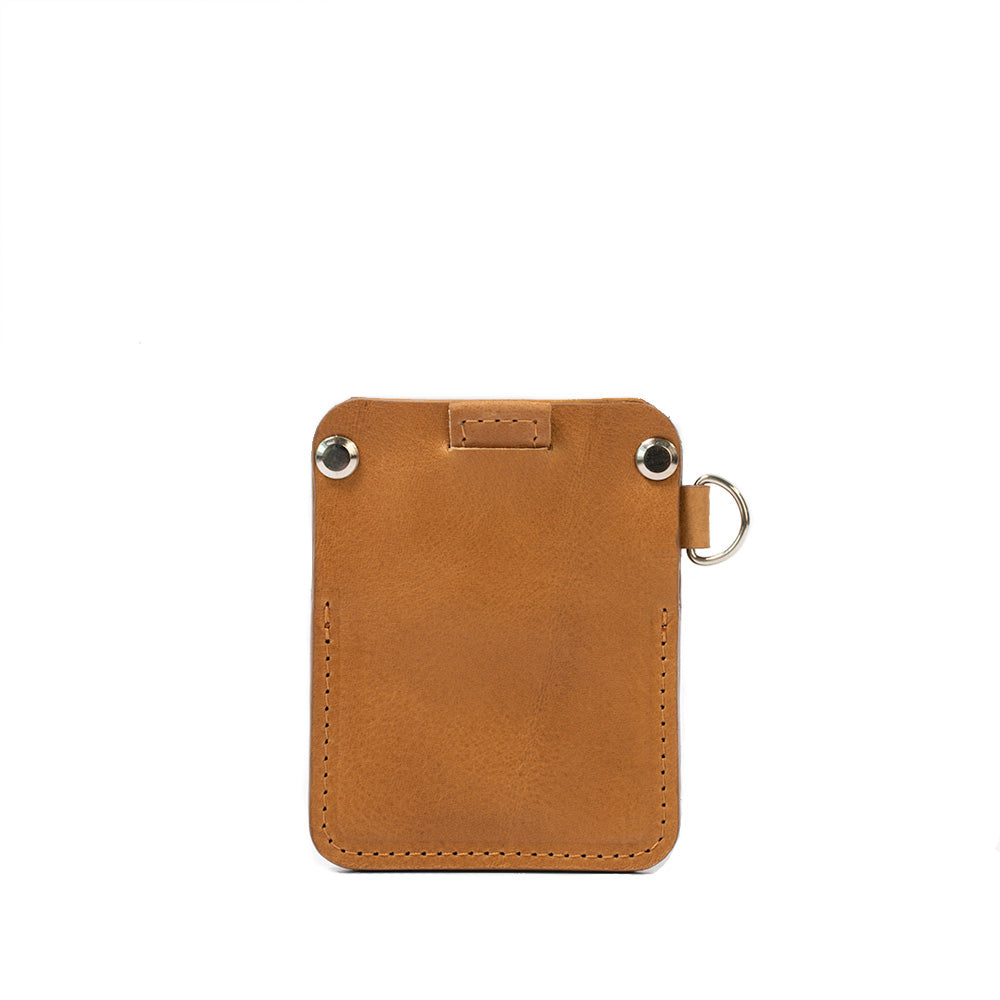 A stylish leather AirTag wallet with D-ring, showcasing its compact design and hidden AirTag pocket, perfect for holding cards securely.