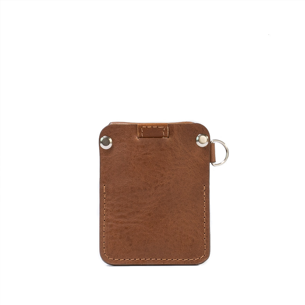 A stylish leather AirTag wallet with D-ring, showcasing its compact design and hidden AirTag pocket, perfect for holding cards securely.