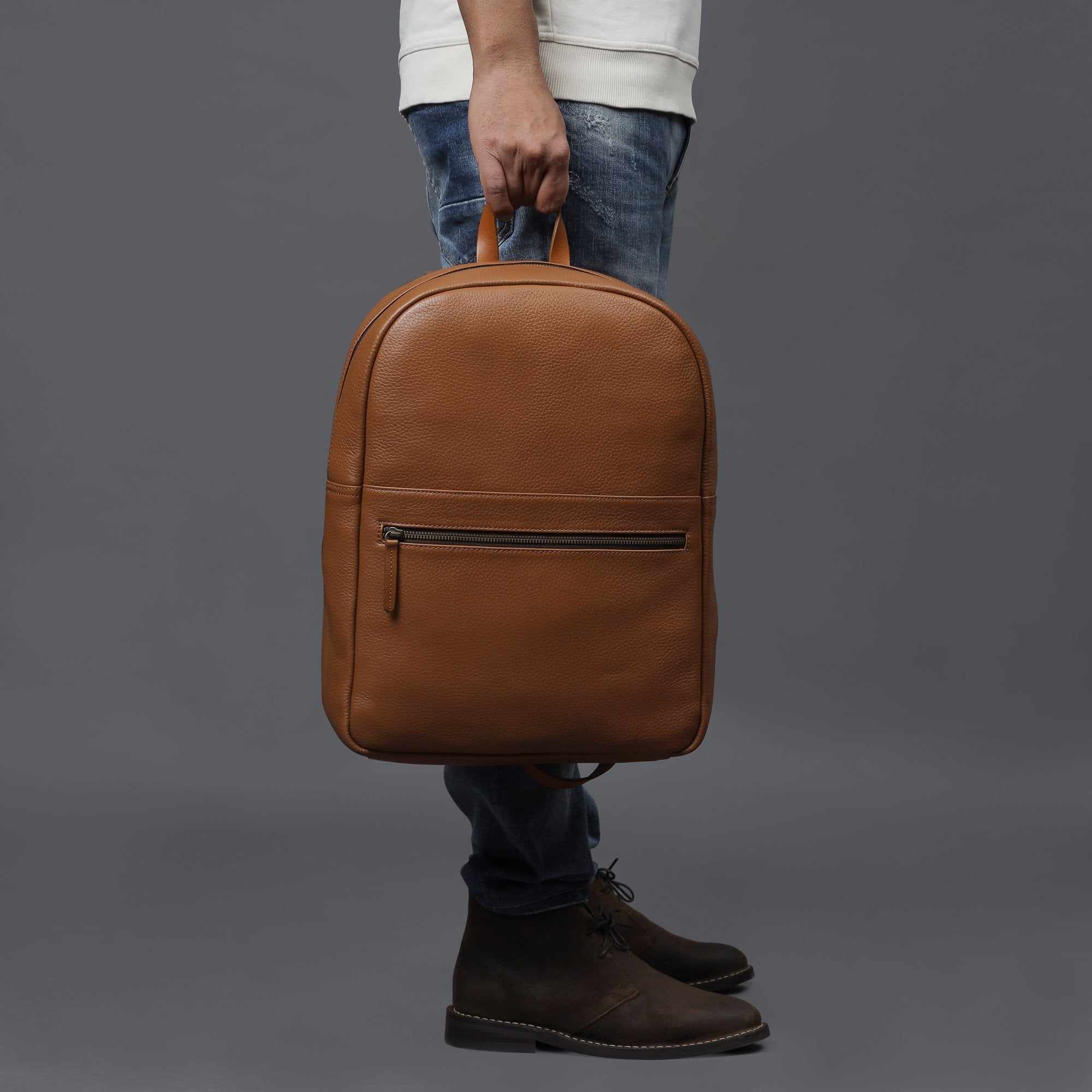 Alabama Leather Backpack made from premium full grain leather, featuring multiple pockets and adjustable padded straps, ideal for everyday use.