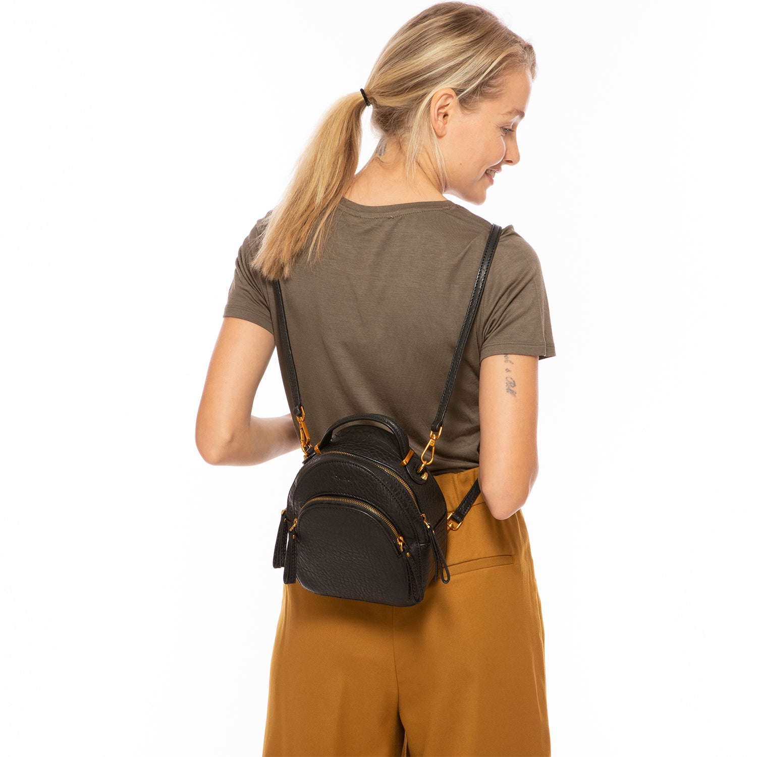 Amanda Black Leather Convertible Backpack Purse with gold hardware and teal lining, showcasing its stylish design and multiple pockets.