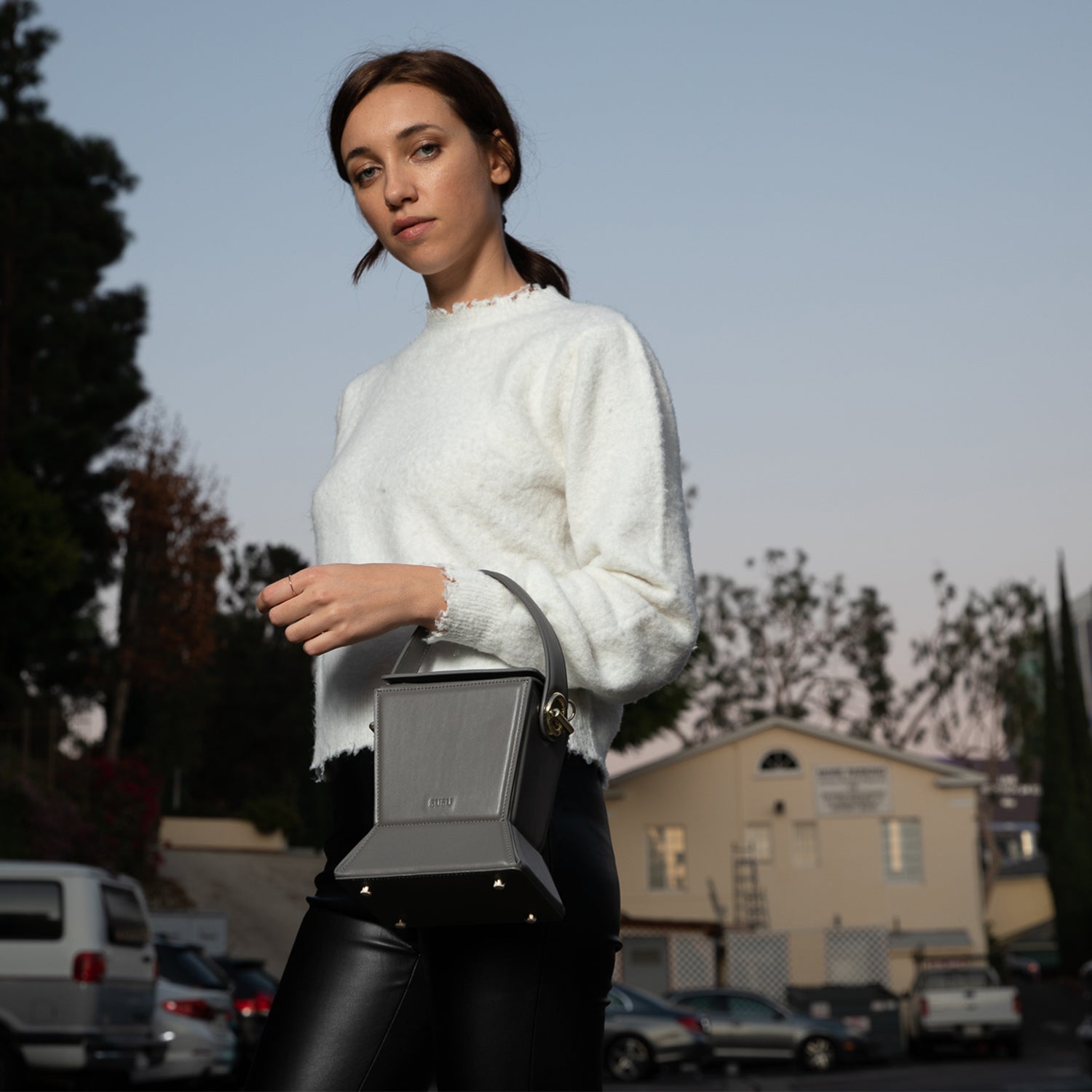 Amber Leather Bucket Bag in Gray with geometric design, gold hardware, and coffee cotton lining.