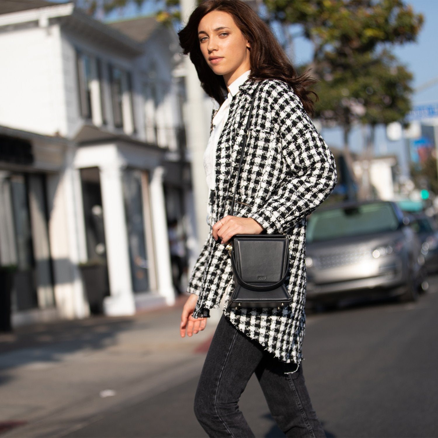 Amber Leather Bucket Purse in black with geometric design, gold hardware, and coffee cotton lining, showcasing its stylish and functional features.