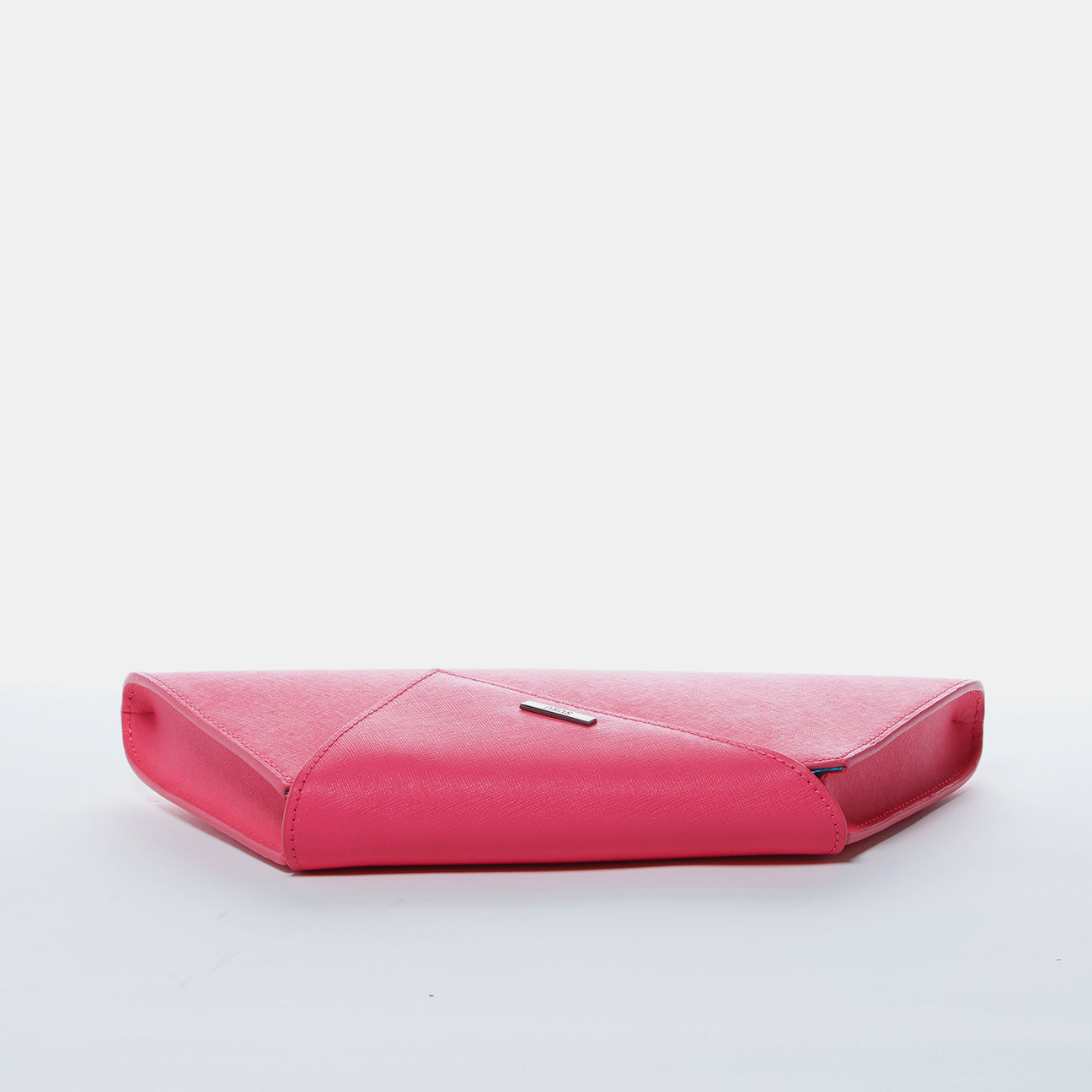 Angelica Hot Pink Leather Clutch Bag with diagonal flap and teal lining, featuring a removable chain strap.