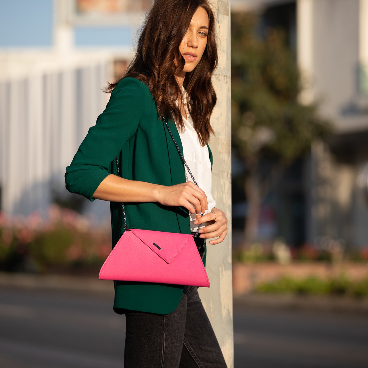 Angelica Hot Pink Leather Clutch Bag with diagonal flap and teal lining, featuring a removable chain strap.