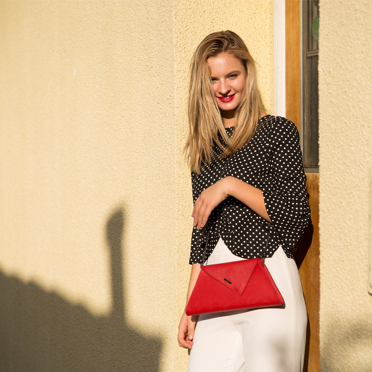 Angelica Red Clutch Purse made from Saffiano leather with a diagonal flap and removable chain strap.