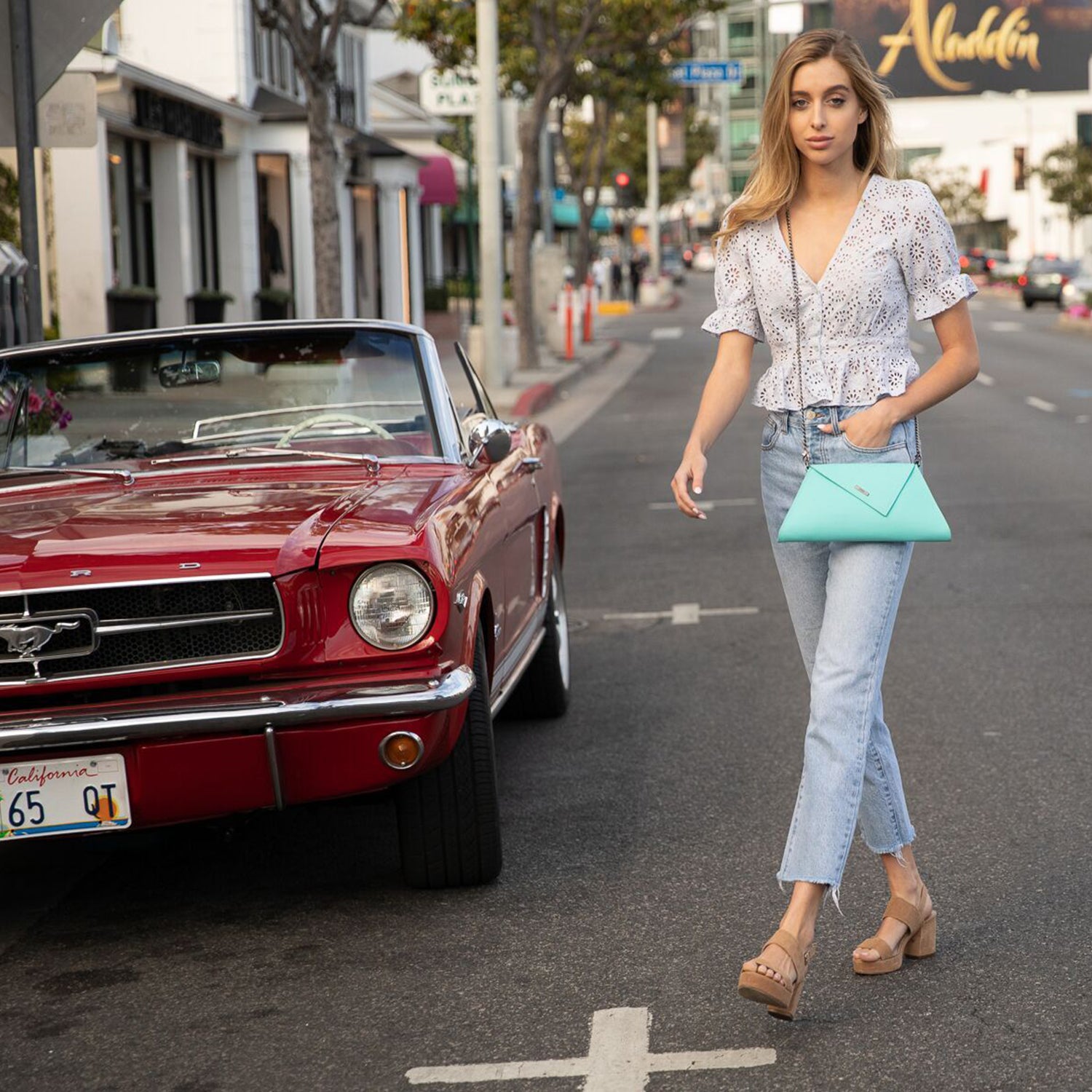 Angelica Turquoise Clutch Leather with diagonal flap, teal lining, and gunmetal hardware, showcasing its stylish design and functionality.