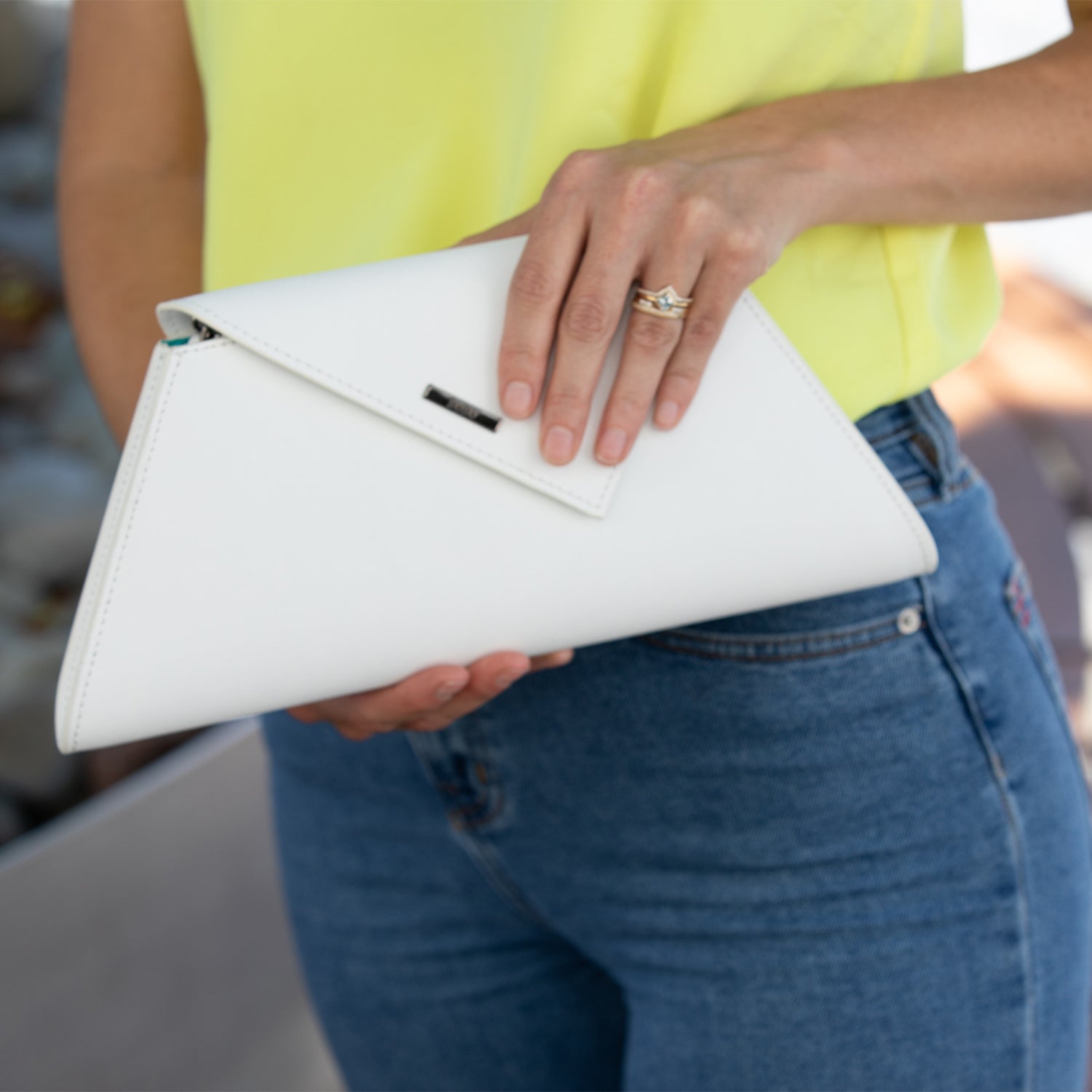 Angelica White Leather Clutch Bag made from Saffiano leather with a diagonal flap and teal interior.