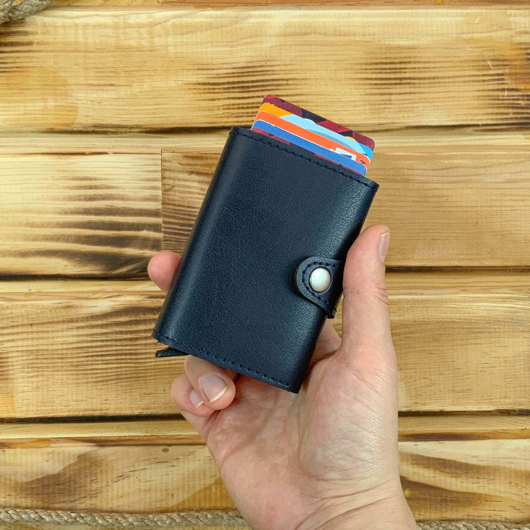 Angora Vegan Leather RFID Mechanism Card Holder in burgundy, navy, and black, showcasing its sleek design and pop-up card feature.