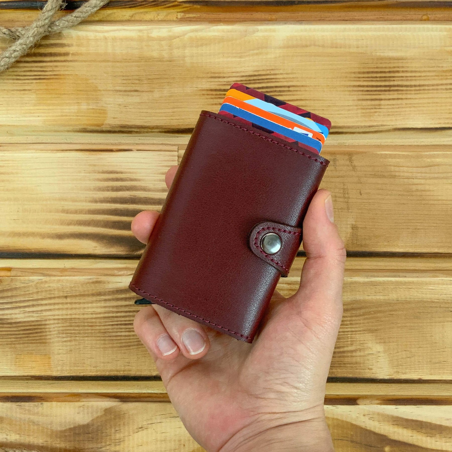 Angora Vegan Leather RFID Mechanism Card Holder in burgundy, navy, and black, showcasing its sleek design and pop-up card feature.