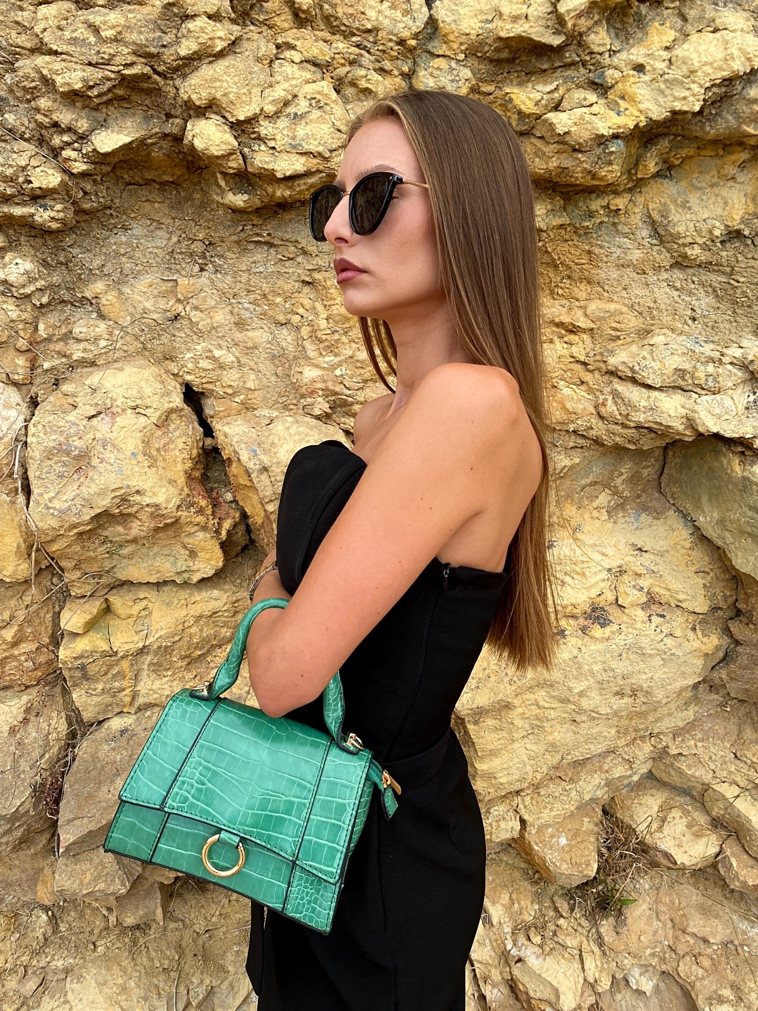 Animal print shoulder bag in green and black with adjustable strap and metallic detail.