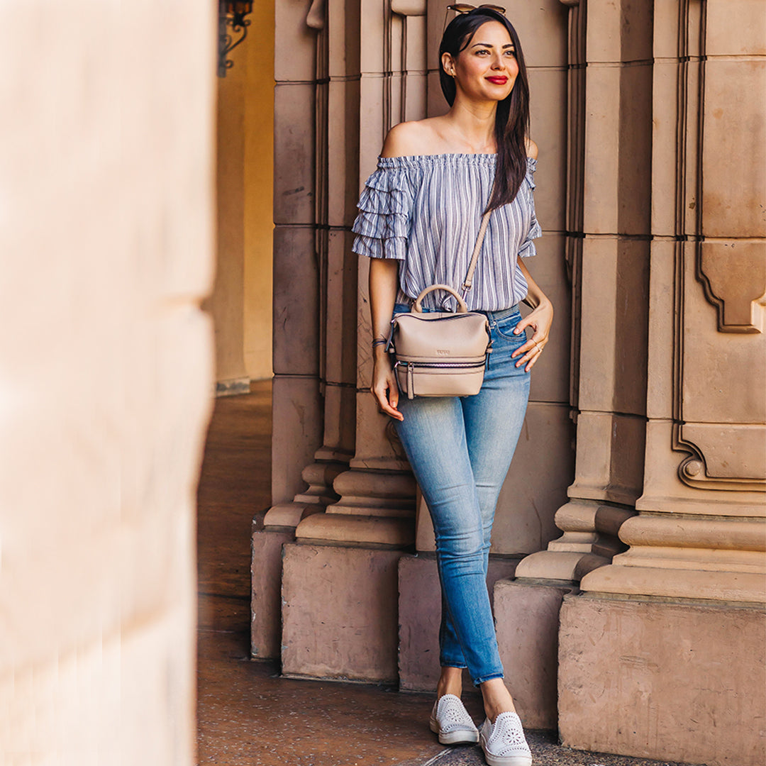 Ashley Small Leather Backpack Purse in Beige with silver zippers and leather tassels, showcasing its stylish design and practical features.