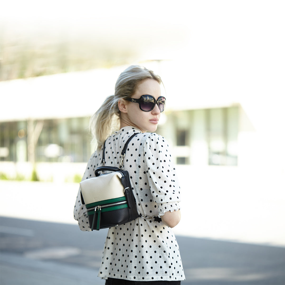 Ashley Small Leather Backpack Purse in off white, green, and black with silver hardware and leather tassels.