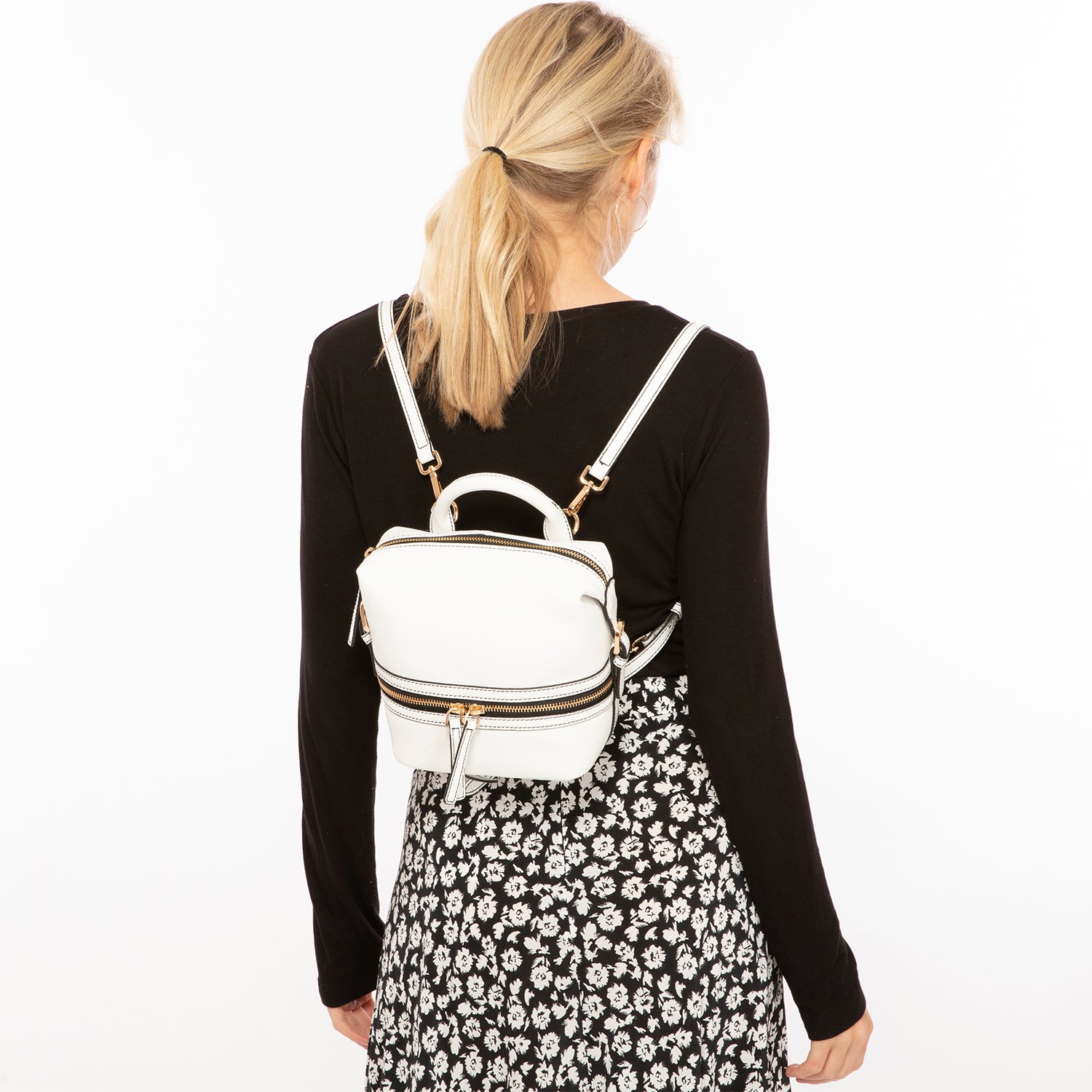 Ashley Small White Leather Backpack Purse featuring genuine pebble leather, gold hardware, and a vibrant red interior.