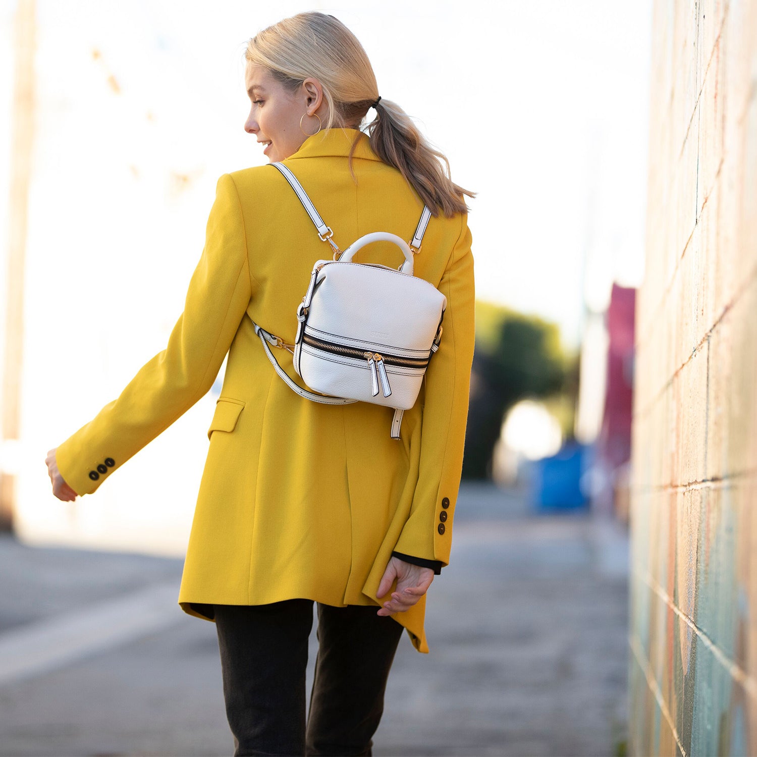 Ashley Small White Leather Backpack Purse featuring genuine pebble leather, gold hardware, and a vibrant red interior.