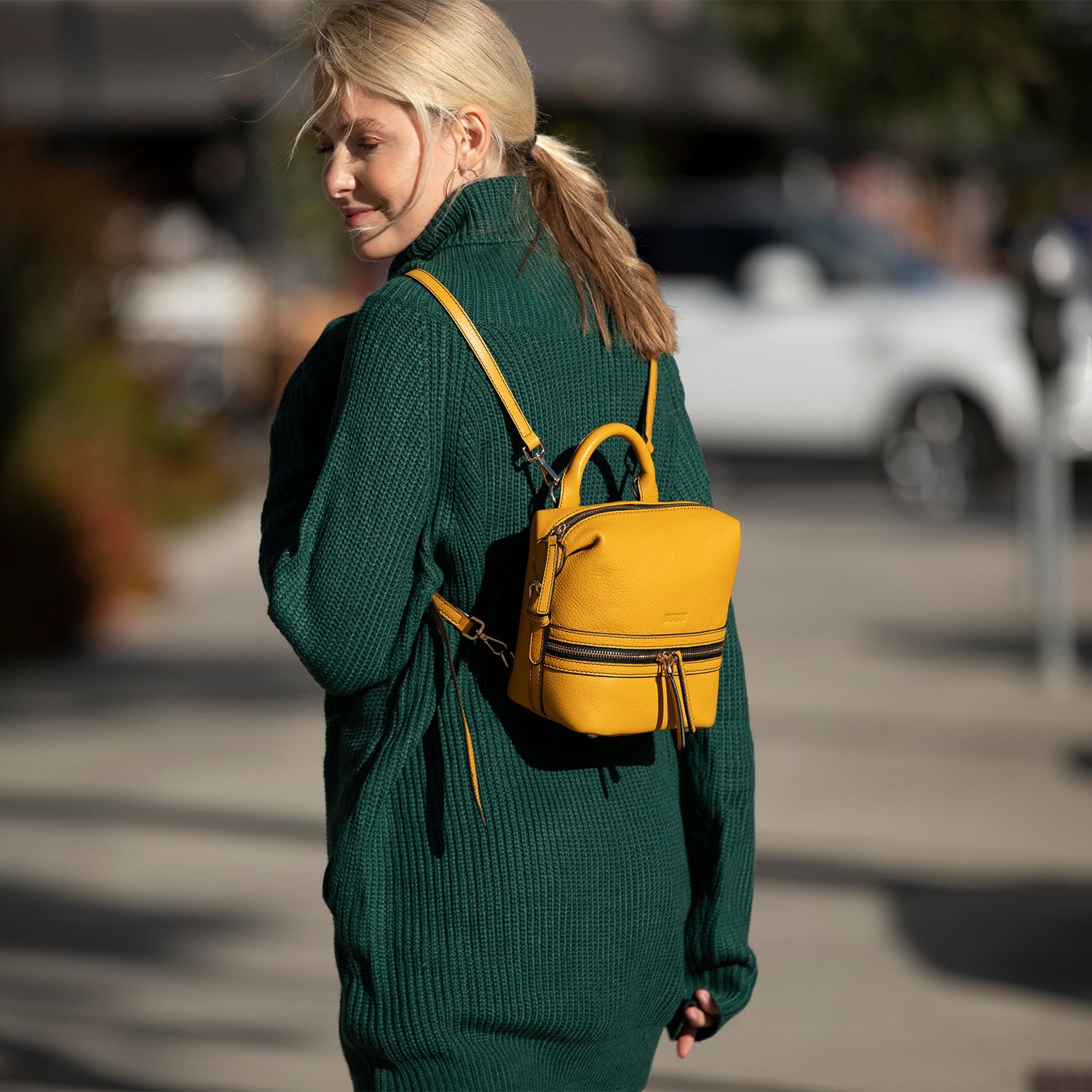 Ashley Small Yellow Leather Backpack featuring genuine pebble leather, gold zippers, and stylish tassels.