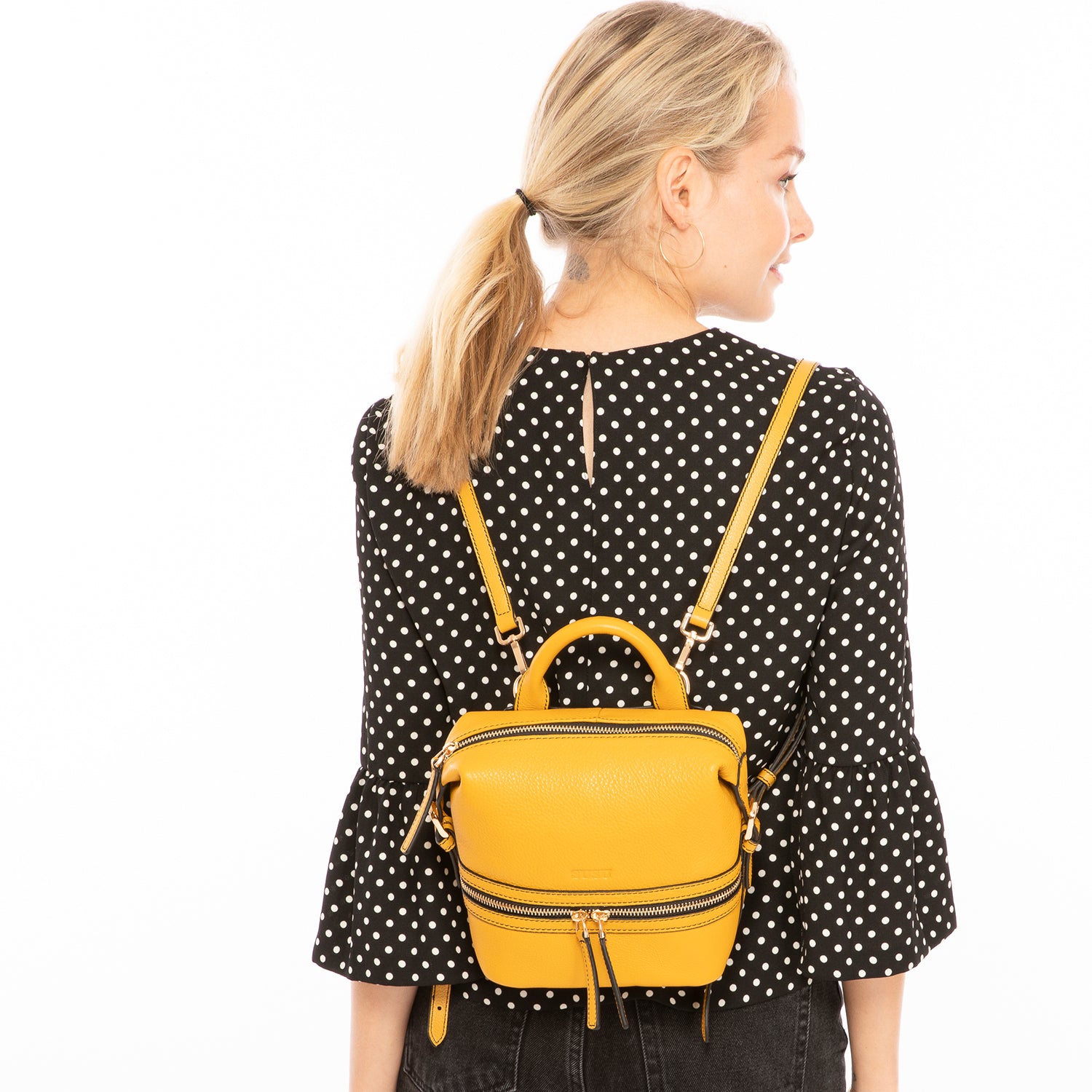 Ashley Small Yellow Leather Backpack featuring genuine pebble leather, gold zippers, and stylish tassels.