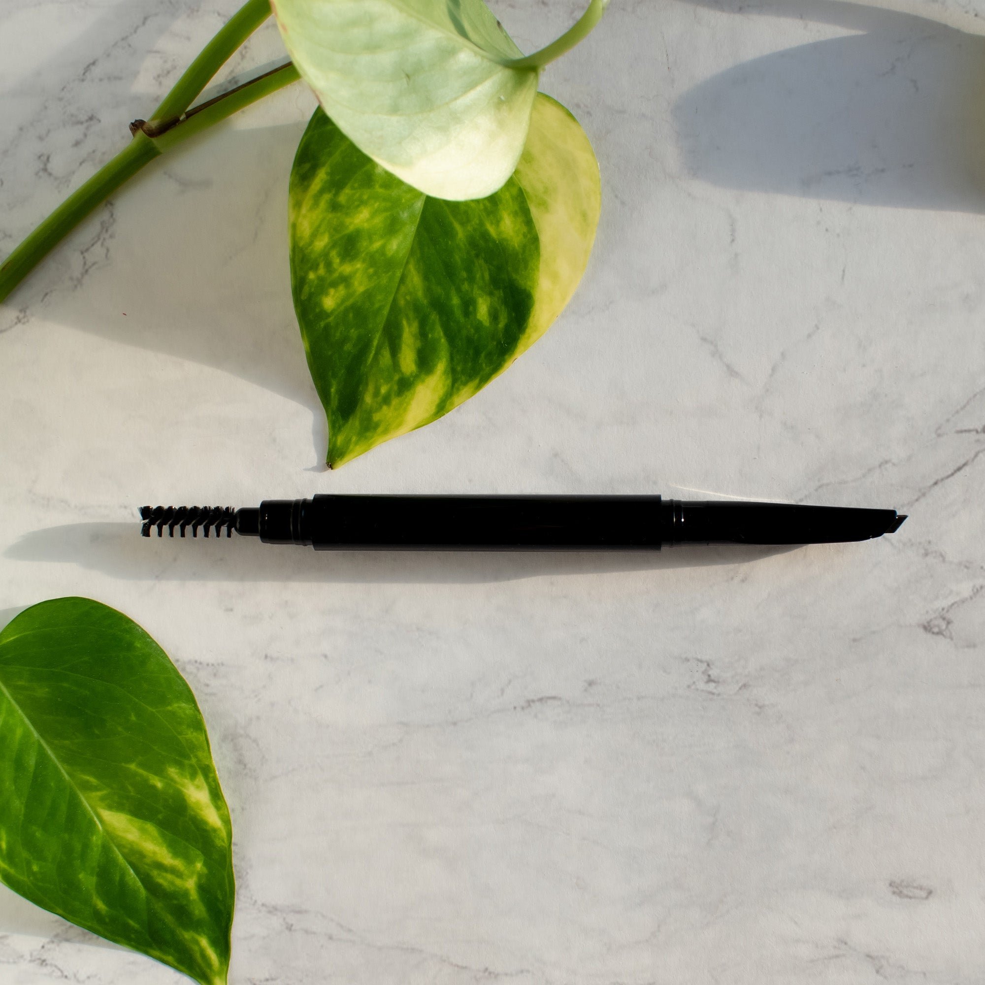 Automatic Eyebrow Pencil in Brown with dual tips for precise application and blending, showcasing its angled and spooly ends.