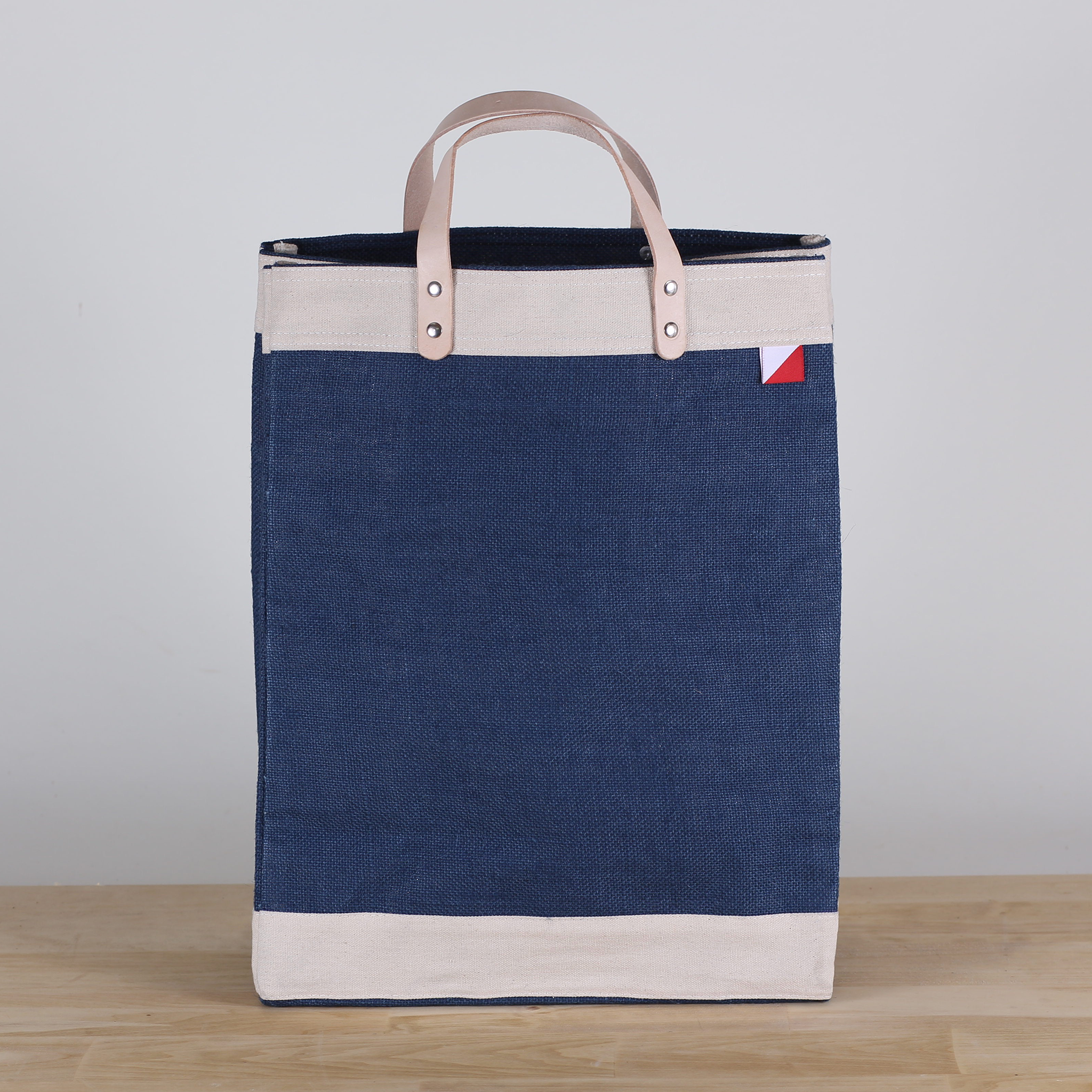 Bazaar Jute and Leather Tote Bag featuring eco-friendly jute, leather handles, and a stylish golden fabric design.