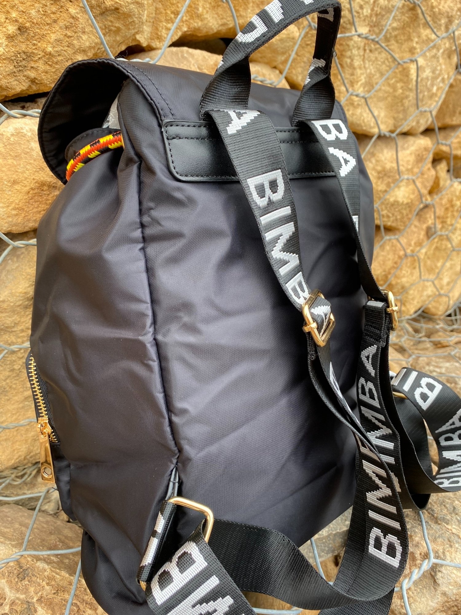 Belted Blue Backpack featuring shiny gold hardware and bright belt accent, perfect for daily use and adventures.