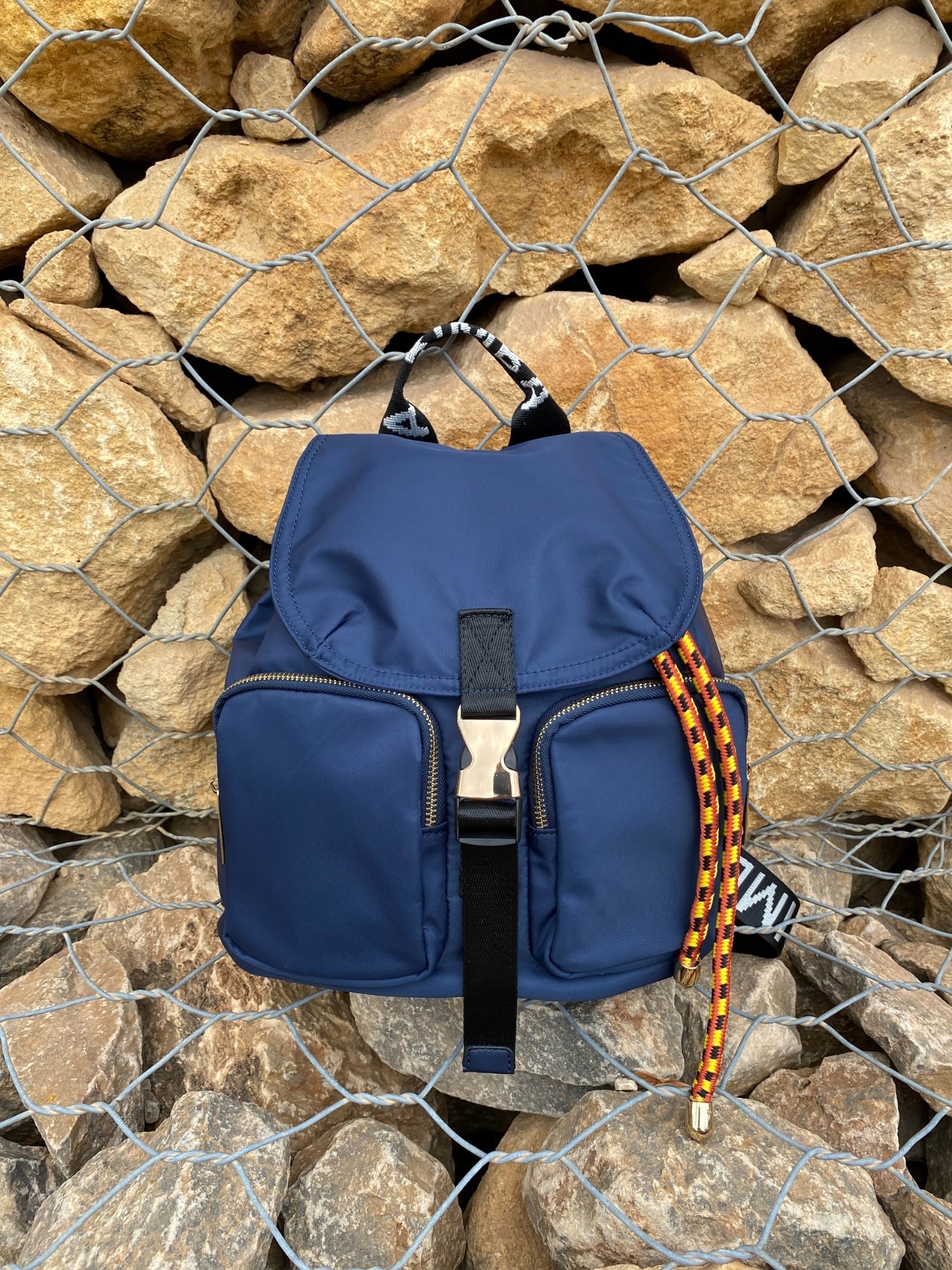 Belted Blue Backpack featuring shiny gold hardware and bright belt accent, perfect for daily use and adventures.