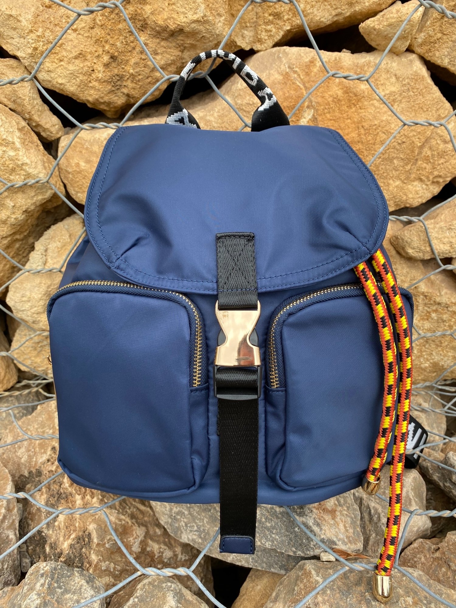 Belted Blue Backpack featuring shiny gold hardware and bright belt accent, perfect for daily use and adventures.