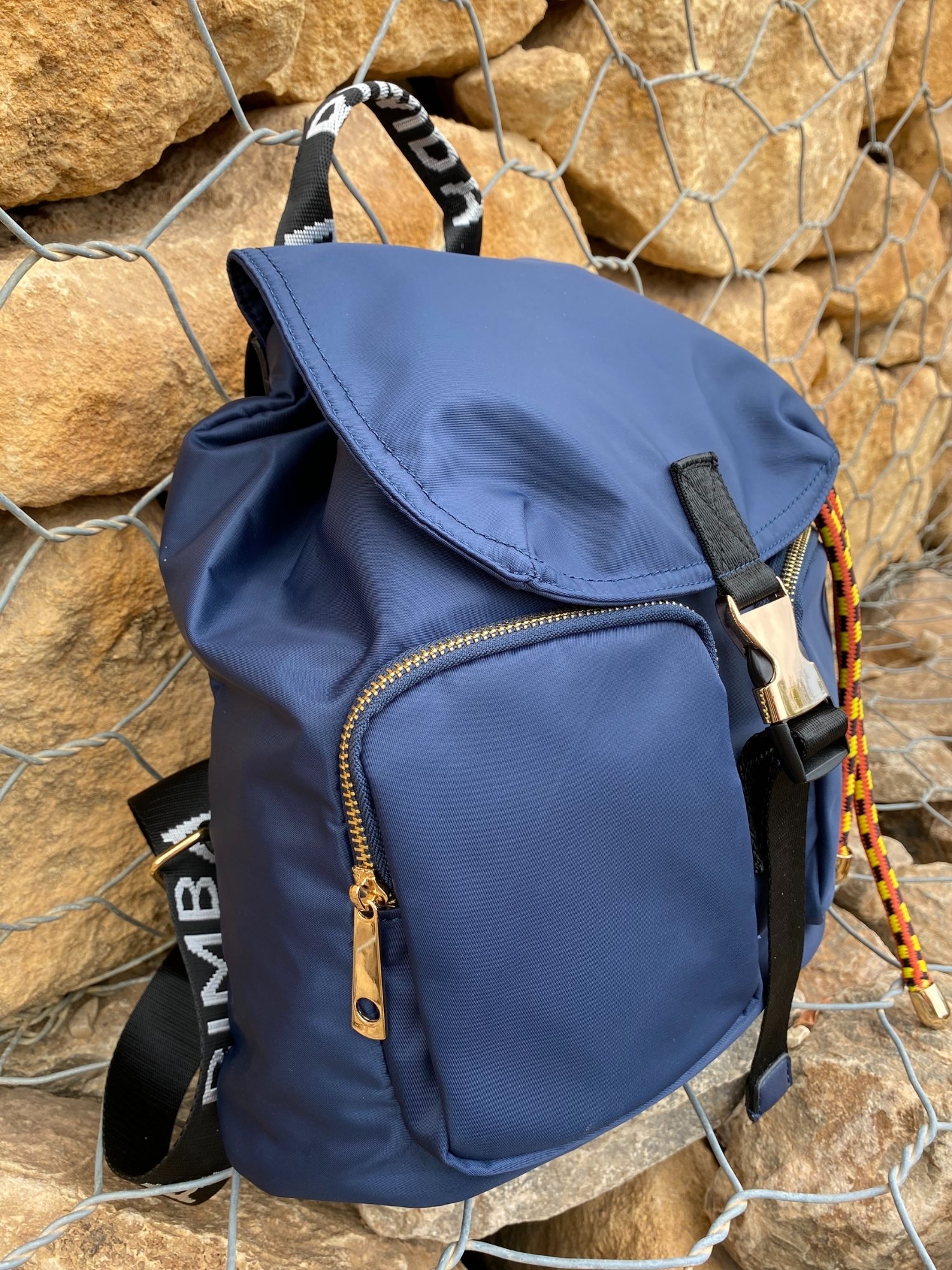 Belted Blue Backpack featuring shiny gold hardware and bright belt accent, perfect for daily use and adventures.