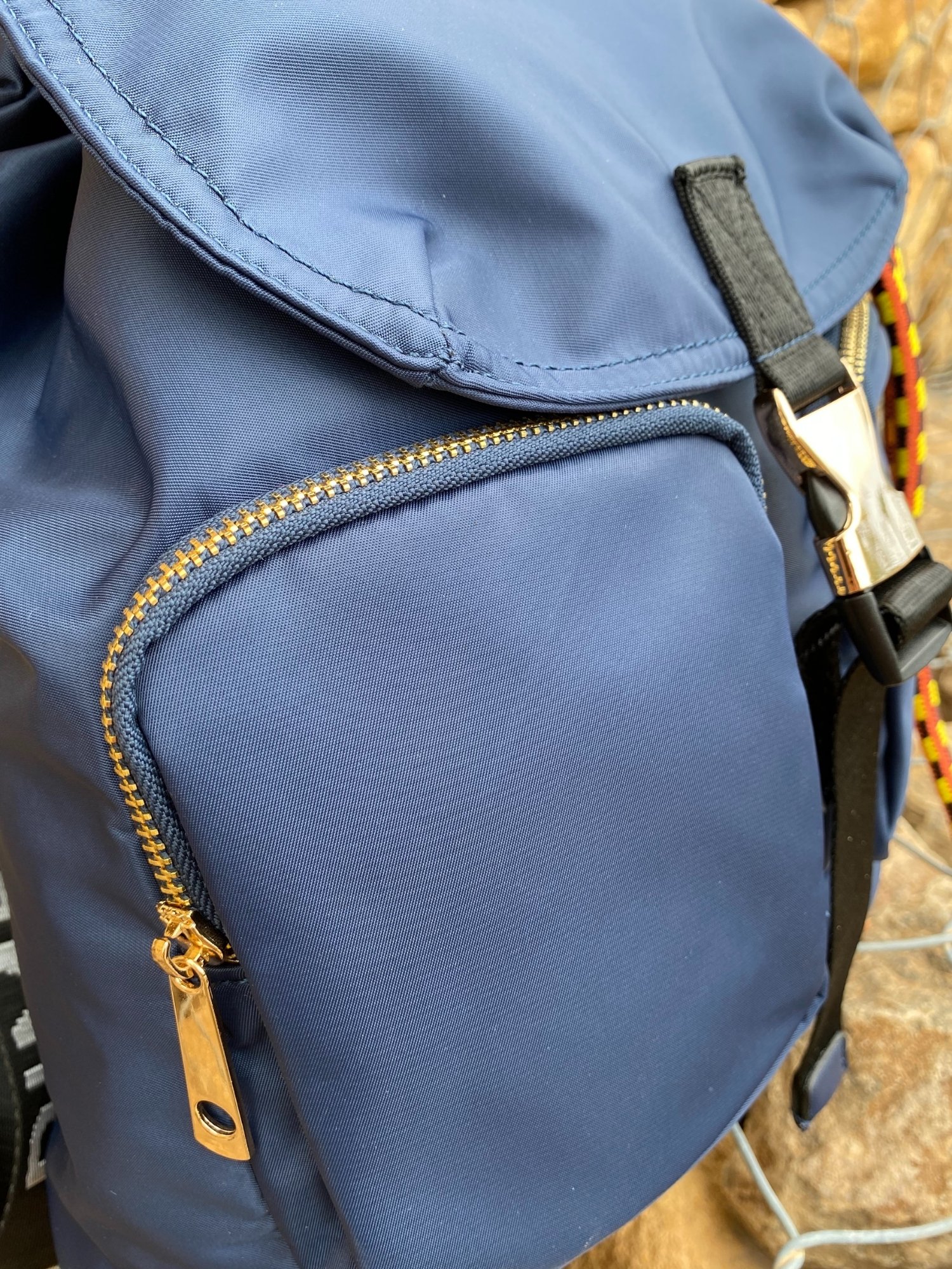 Belted Blue Backpack featuring shiny gold hardware and bright belt accent, perfect for daily use and adventures.