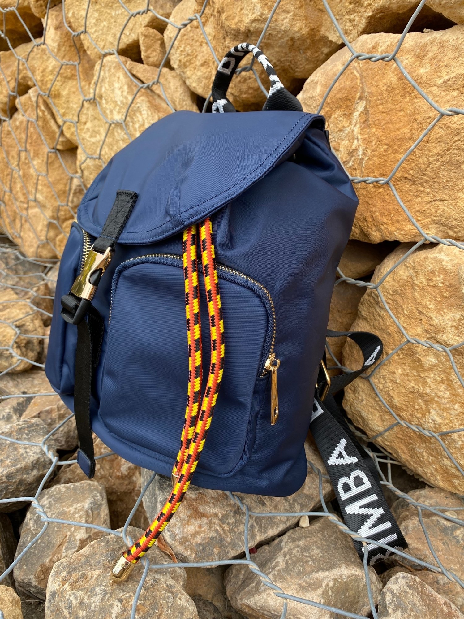 Belted Blue Backpack featuring shiny gold hardware and bright belt accent, perfect for daily use and adventures.