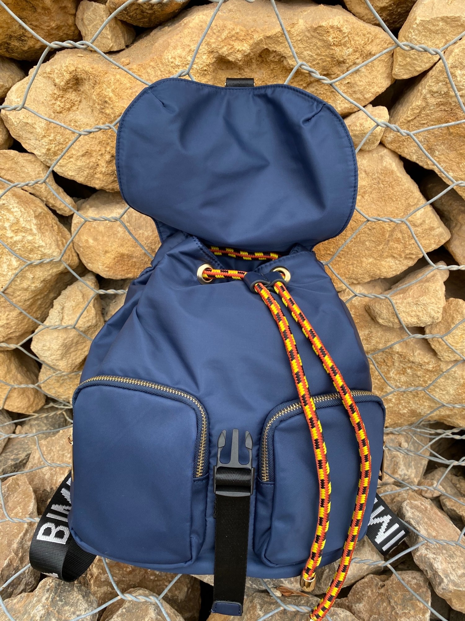 Belted Blue Backpack featuring shiny gold hardware and bright belt accent, perfect for daily use and adventures.