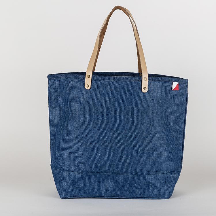 A vibrant Big Jute Colored Tote Bag with leather handles, showcasing its spacious interior and stylish design, perfect for errands and outings.