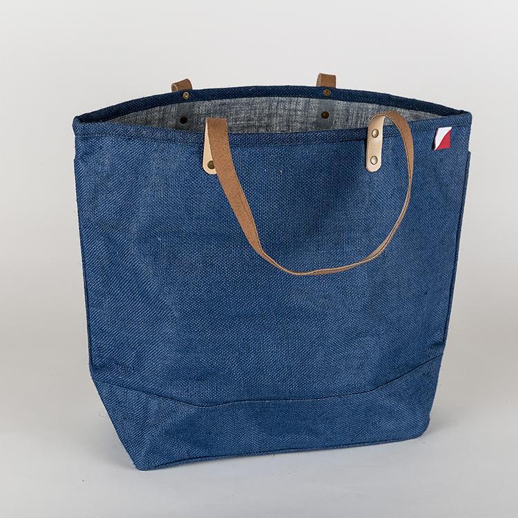 A vibrant Big Jute Colored Tote Bag with leather handles, showcasing its spacious interior and stylish design, perfect for errands and outings.