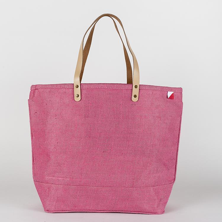 A vibrant Big Jute Colored Tote Bag with leather handles, showcasing its spacious interior and stylish design, perfect for errands and outings.