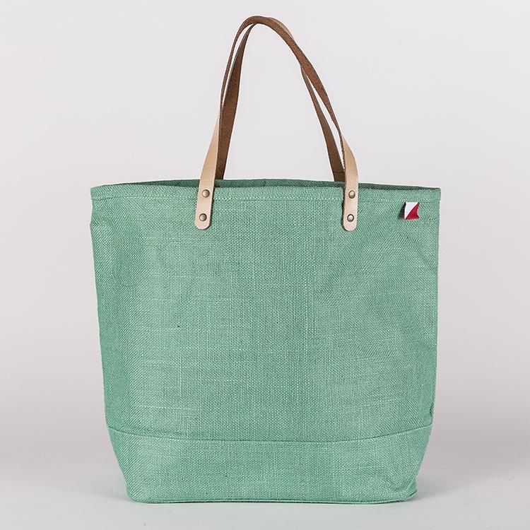 A vibrant Big Jute Colored Tote Bag with leather handles, showcasing its spacious interior and stylish design, perfect for errands and outings.