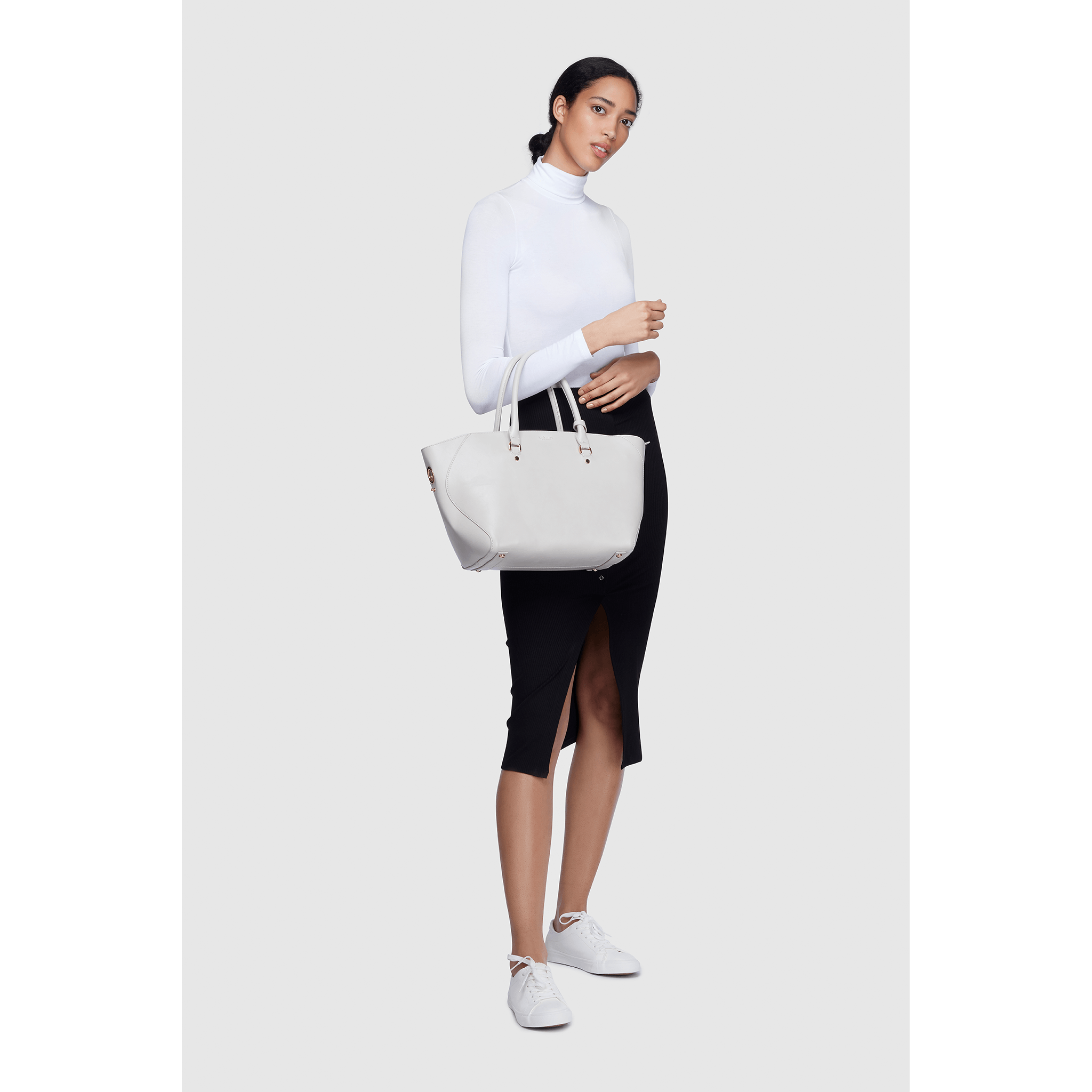 Black Sophie Vegan Leather Tote Bag with matching pouch, showcasing its stylish design and spacious interior.