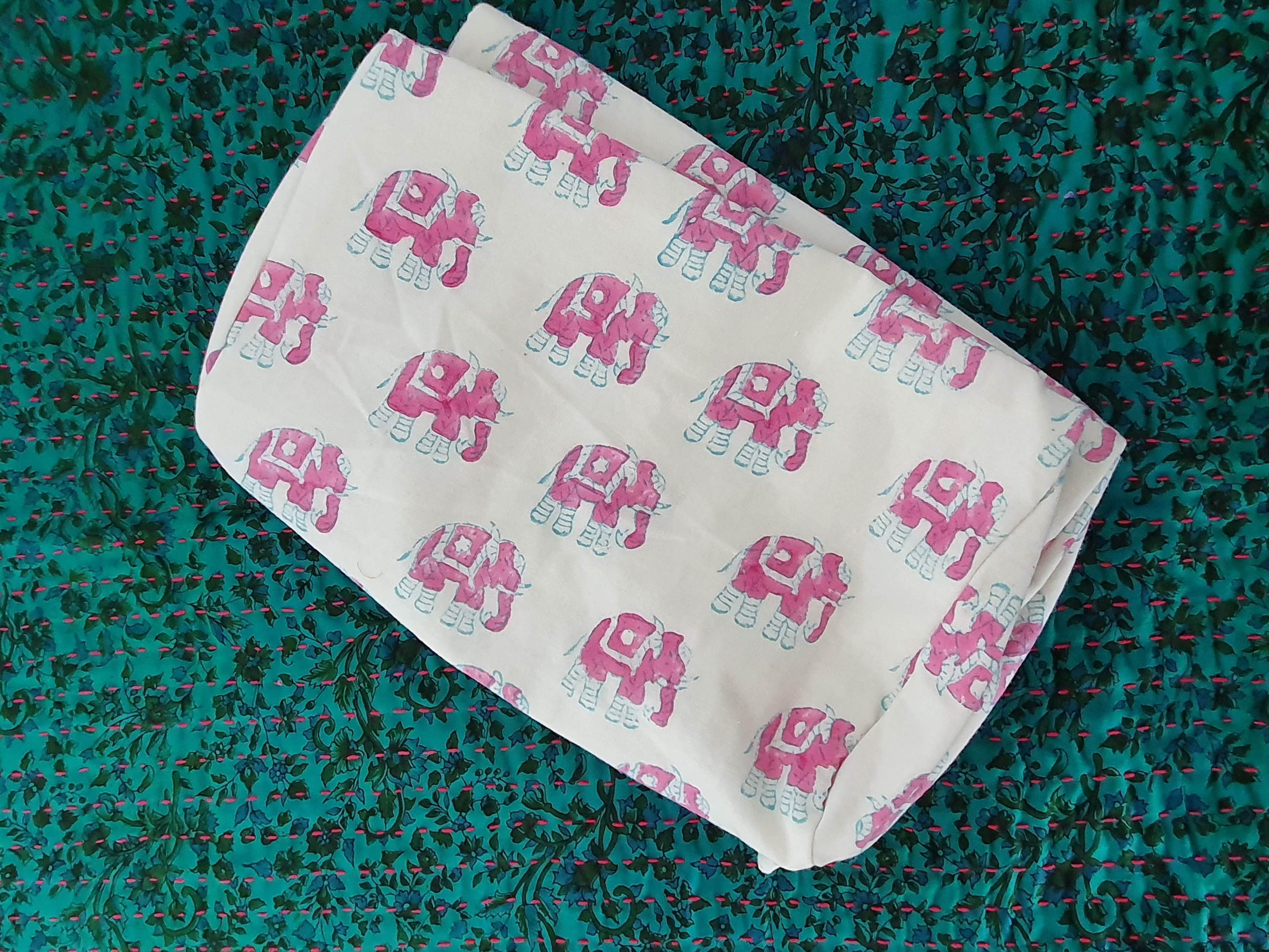 A colorful block-printed elephant toiletry bag featuring vibrant elephants on a cotton fabric, perfect for travel and organization.