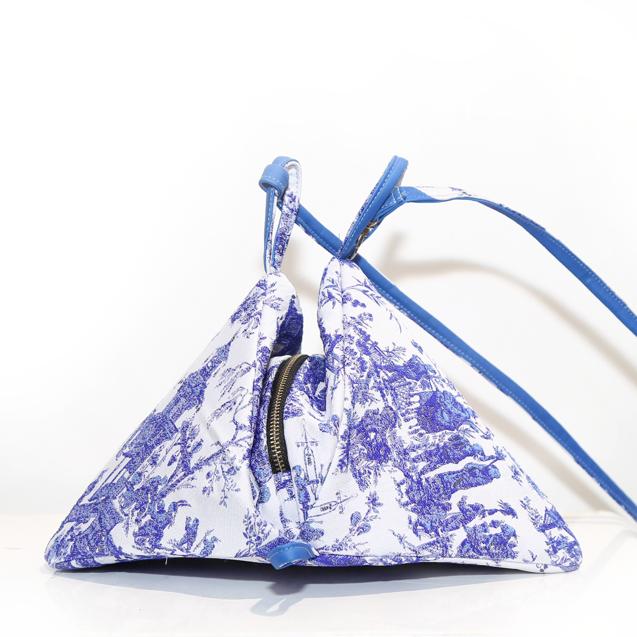 Blue Jacquard Pyramid Backpack showcasing its stylish design and versatile use as a backpack or shoulder bag.