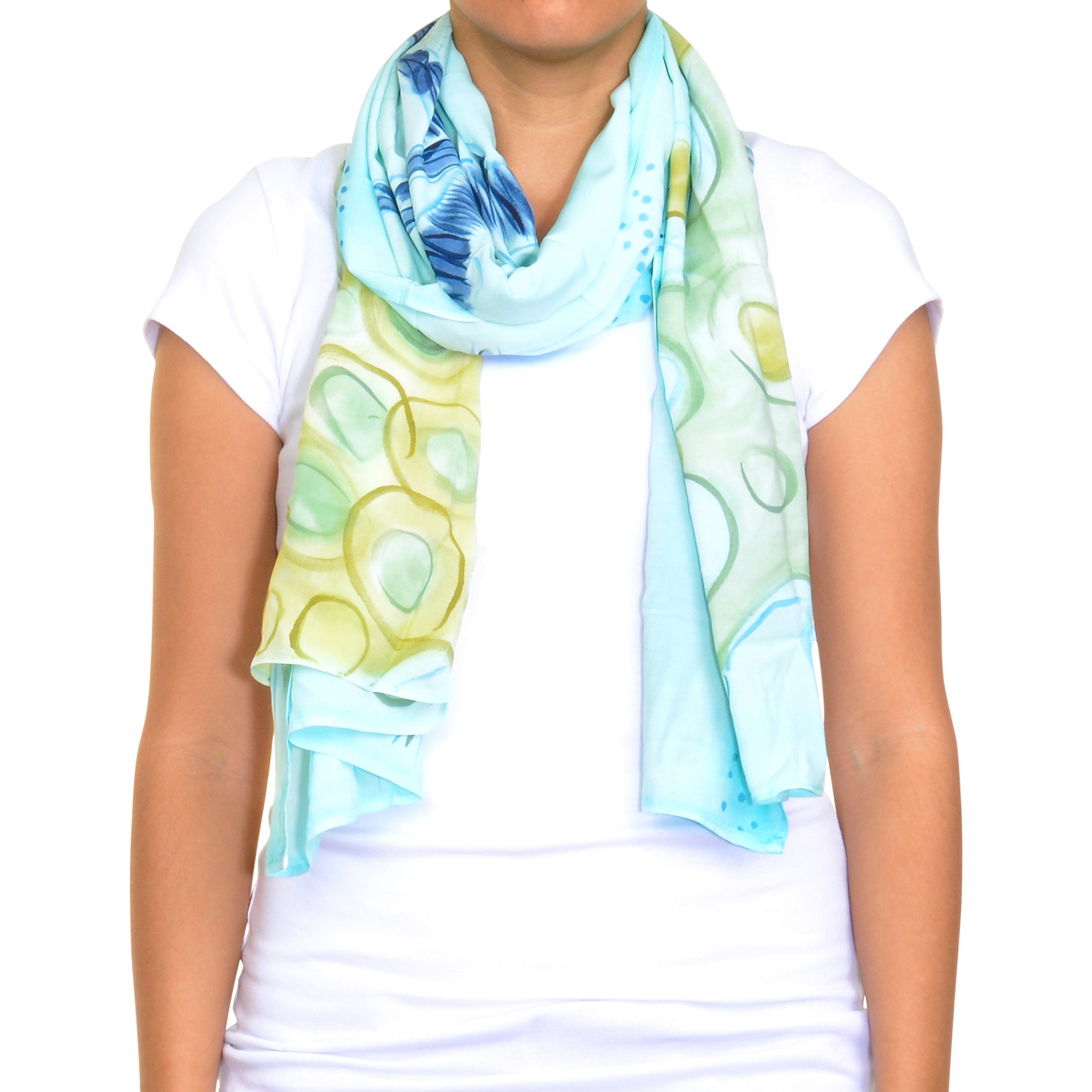 A vibrant Blue Sea hand painted scarf featuring original artwork, showcasing intricate designs and colors, made from soft rayon fabric.