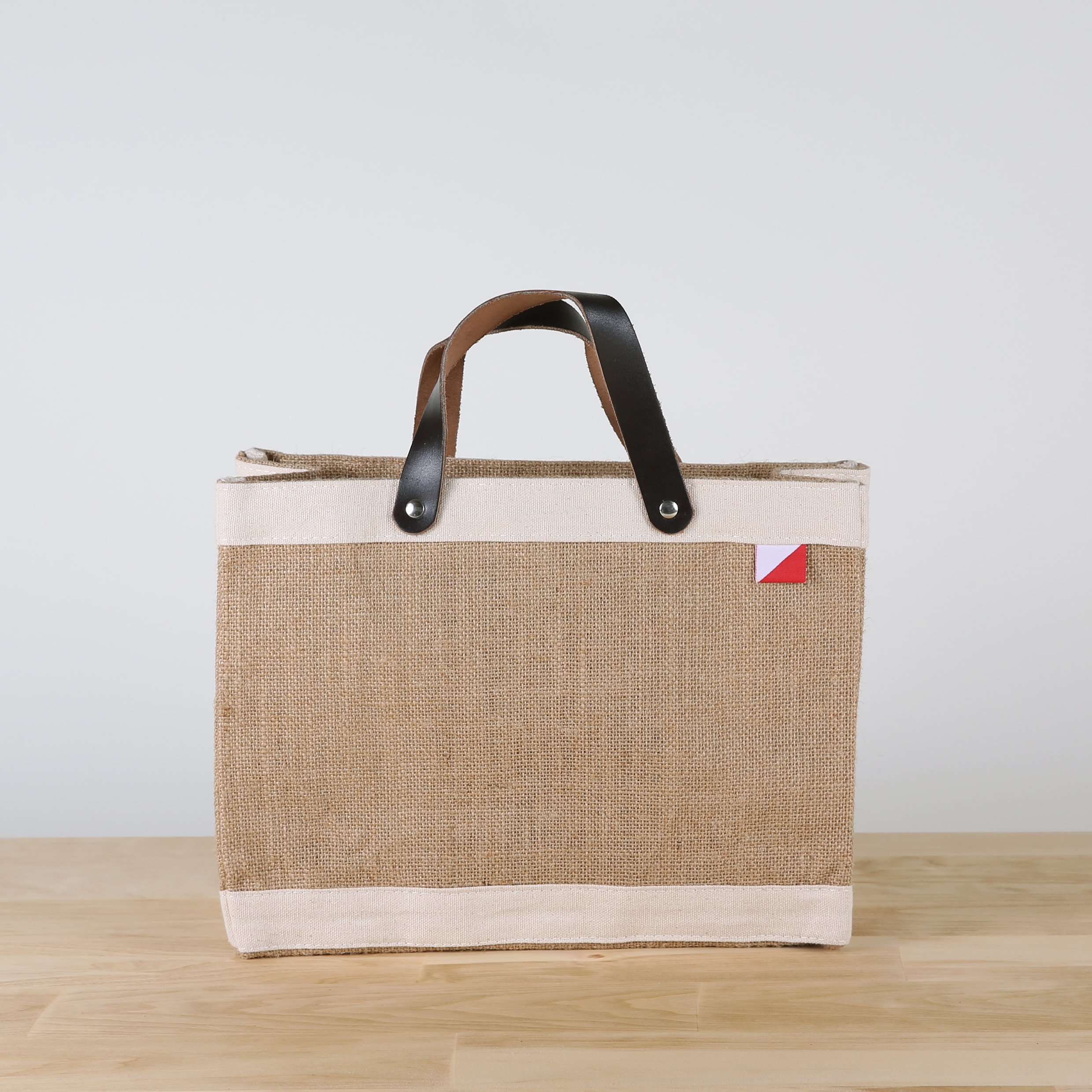 Bodega Jute Tote Bag featuring eco-friendly jute and canvas with leather handles, perfect for daily essentials.