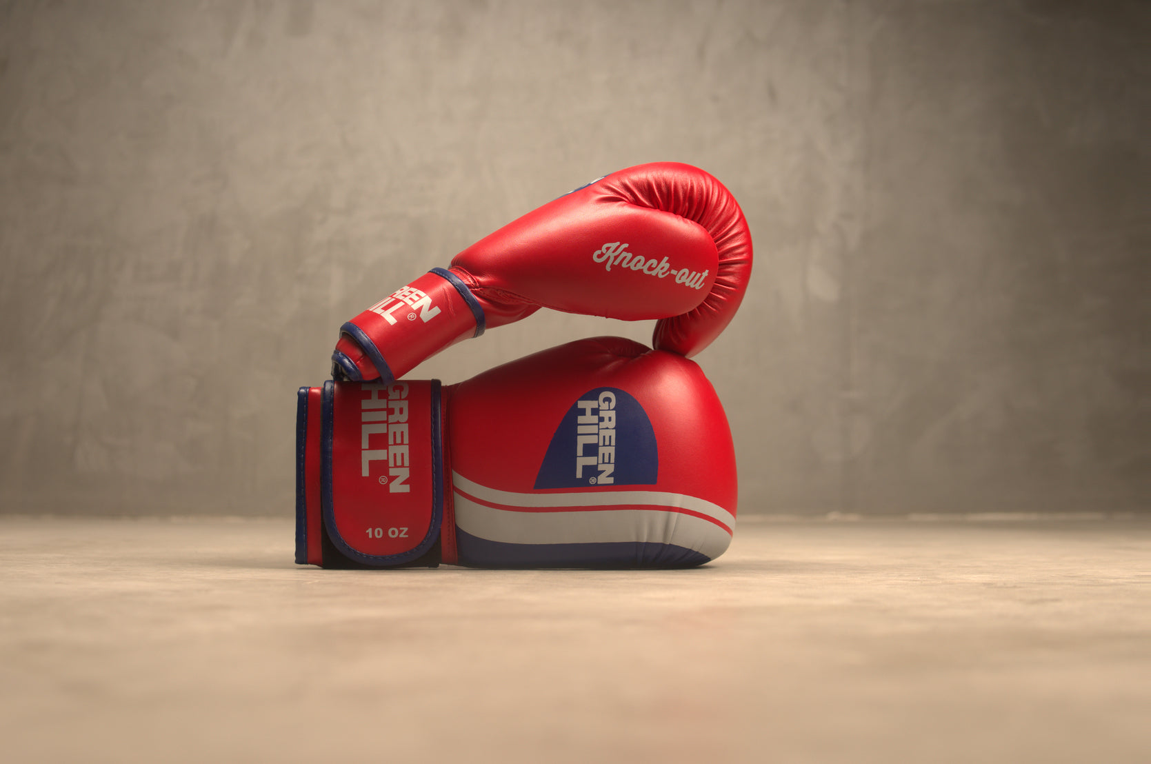 Knock Out boxing gloves made from durable GRX leather, featuring a vibrant color design and secure thumb loop for optimal fit and protection.