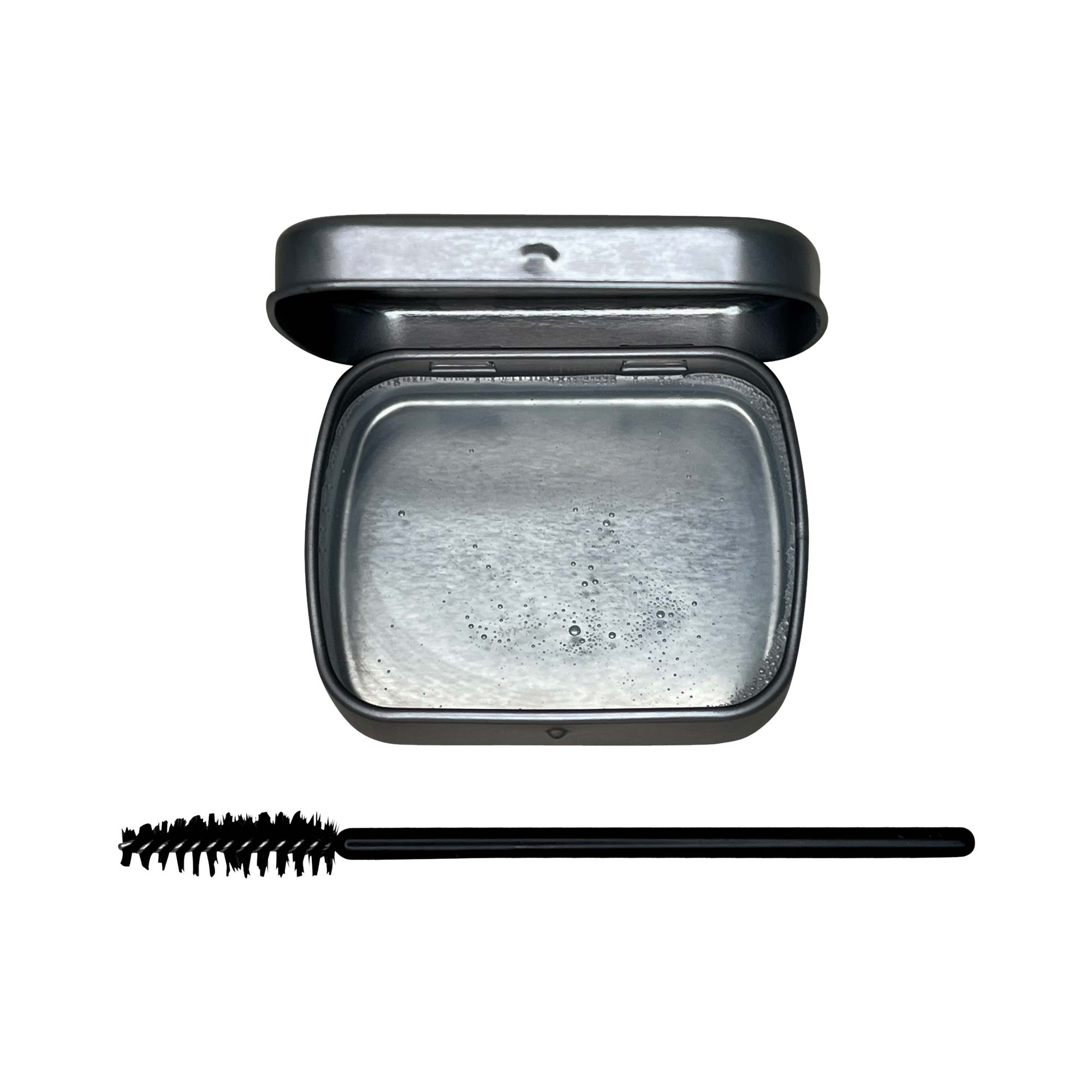 Clear brow soap in a compact container with a wand, designed for styling brows without residue.